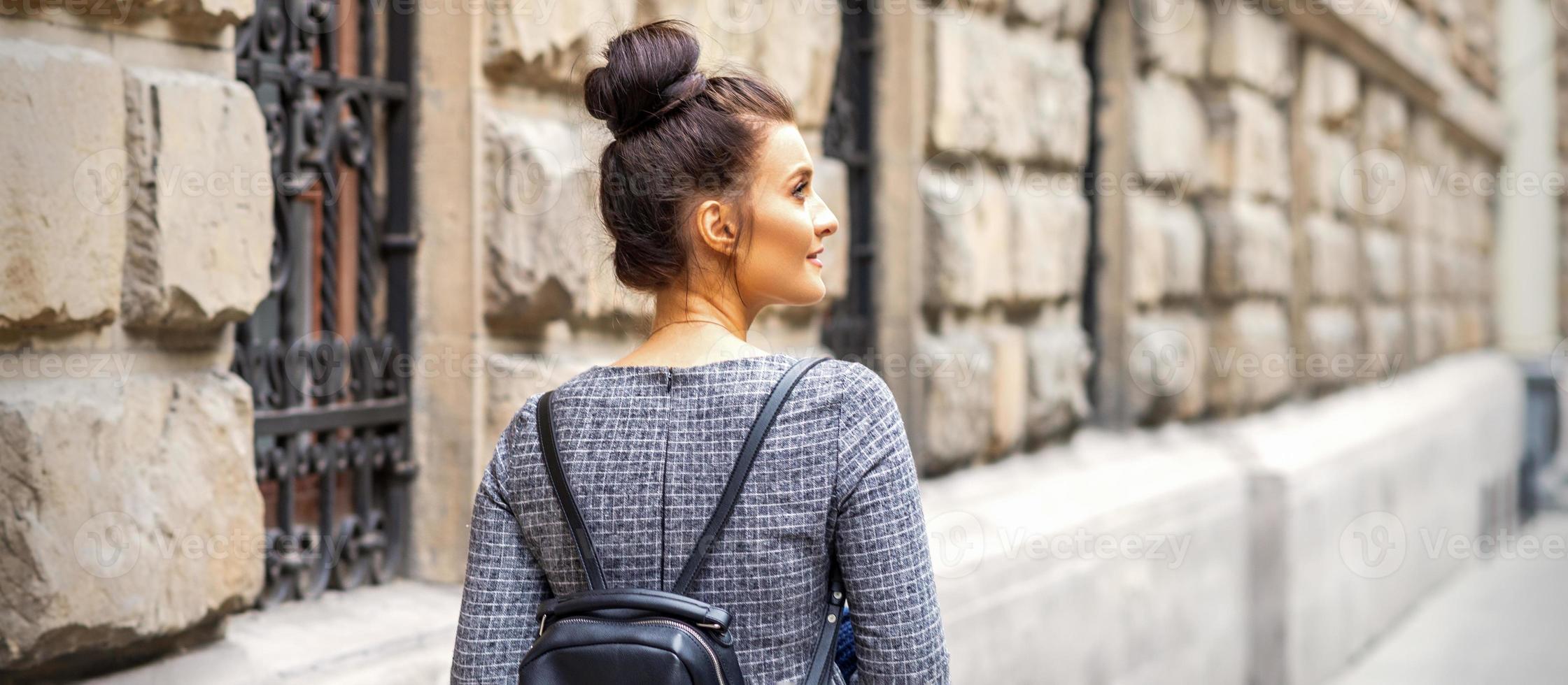 Young woman walks with backpack photo