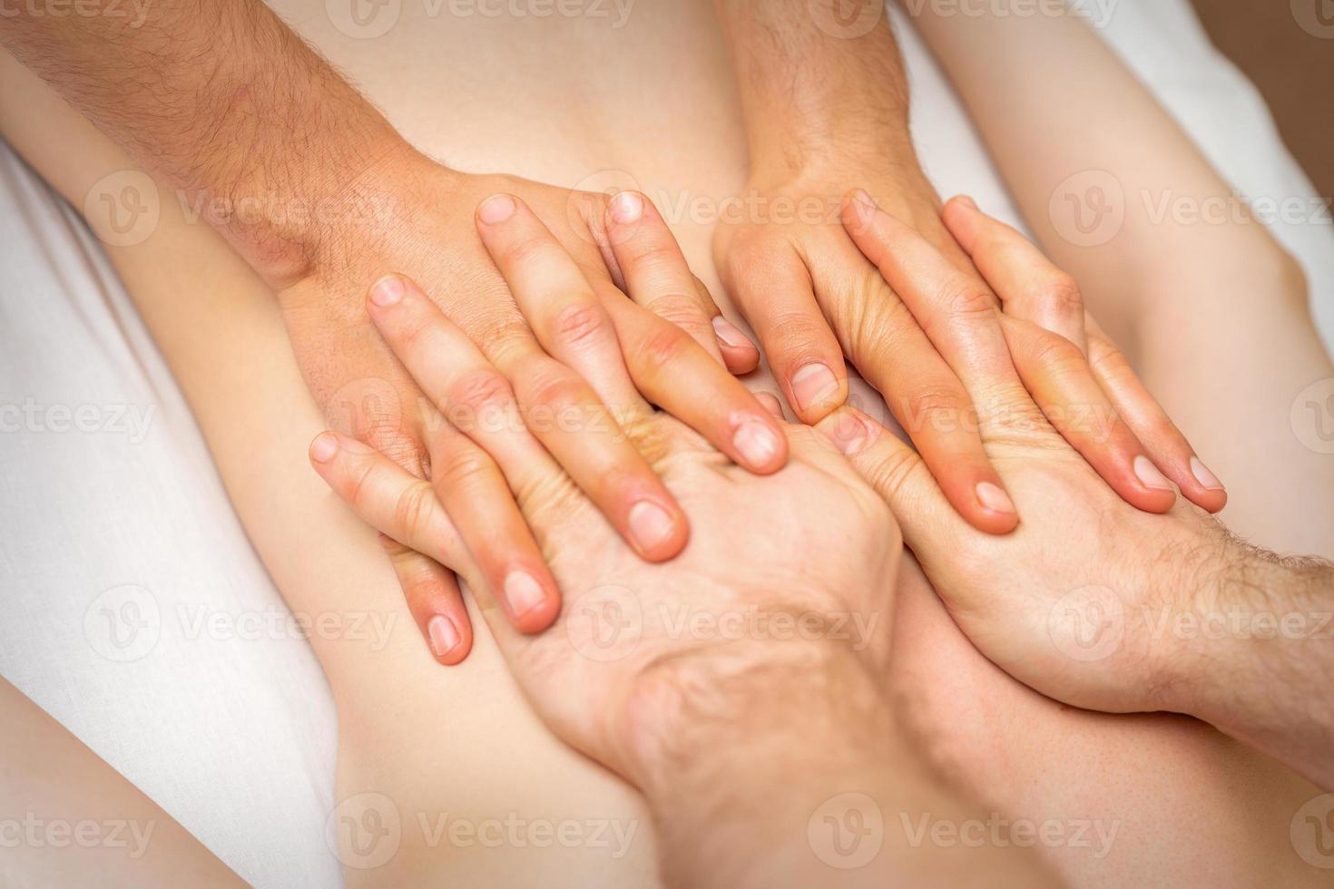 4 hands massage the patient back photo