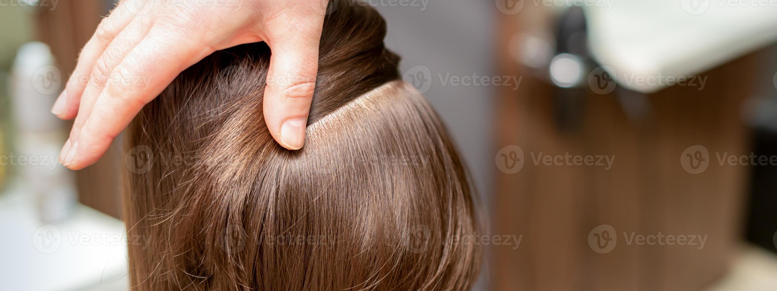 Hairdresser checks short brown hairstyle photo