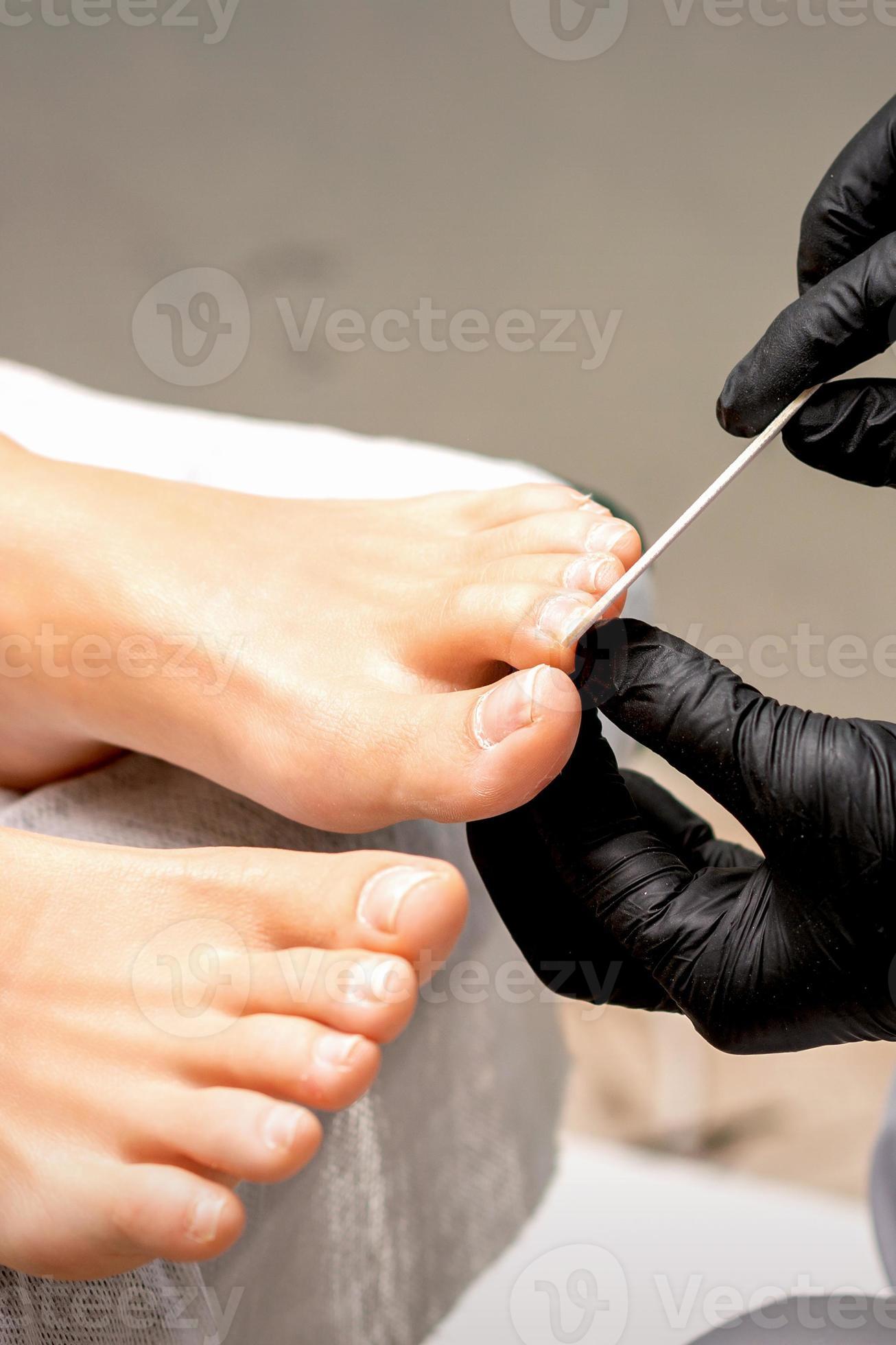 File toenails with nail file 21476401 Stock Photo at Vecteezy