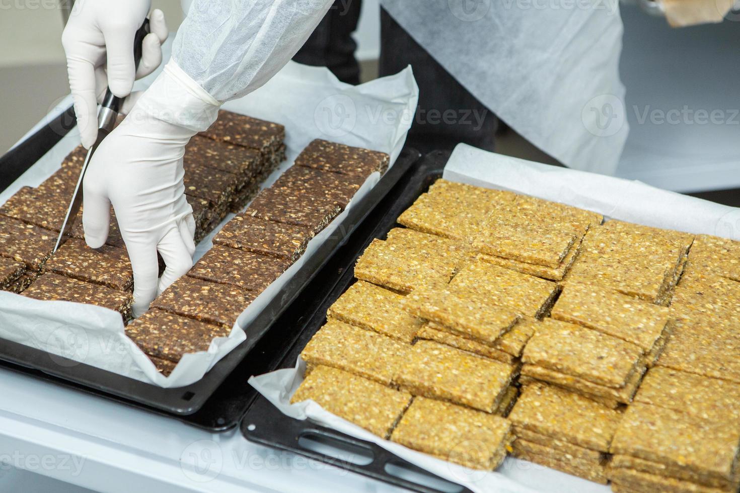 Assortment of cereal or protein bars that leave the assembly line at the factory. Healthy pre or post workout snacks with fruits, nuts and berries. photo