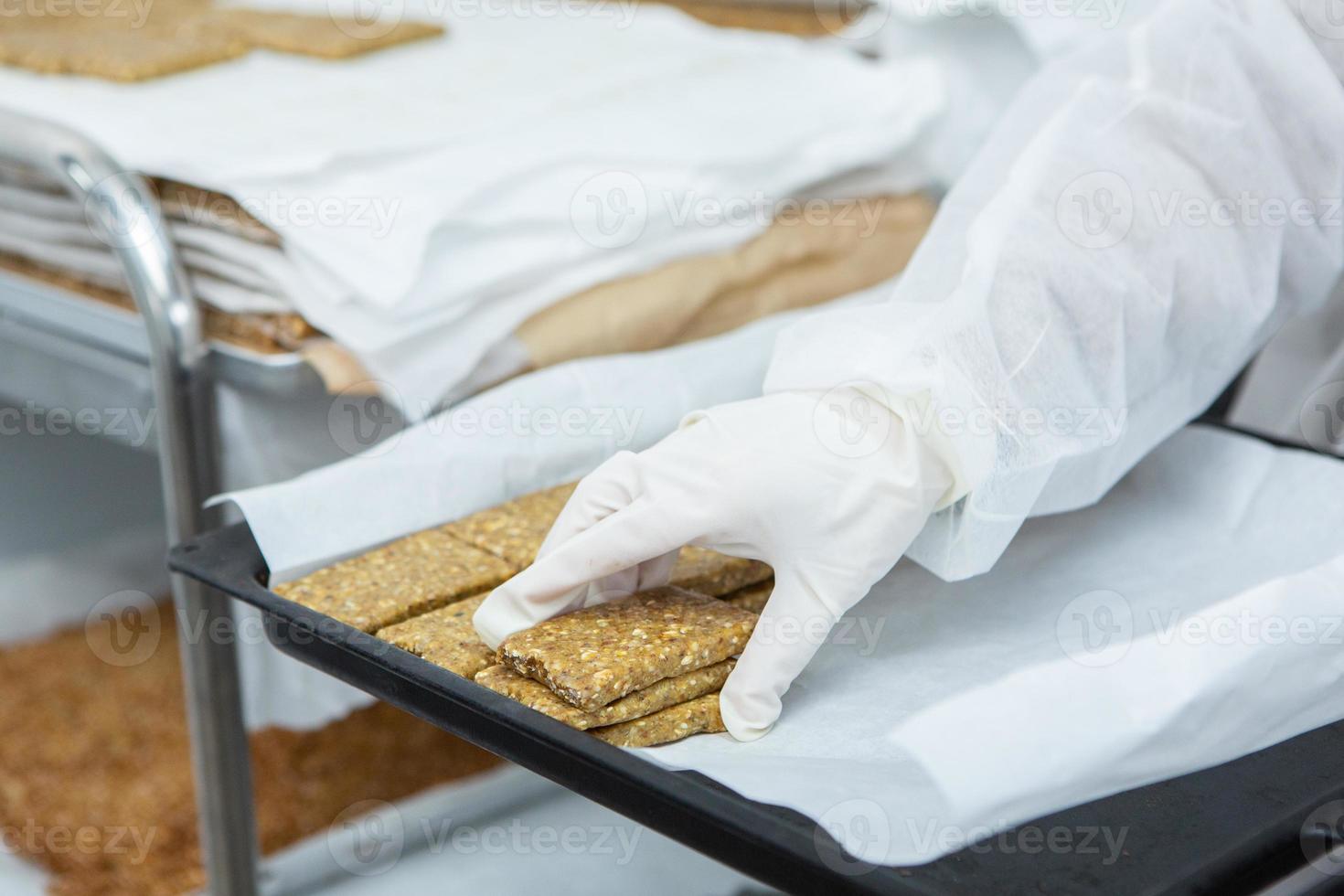 Assortment of cereal or protein bars that leave the assembly line at the factory. Healthy pre or post workout snacks with fruits, nuts and berries. photo