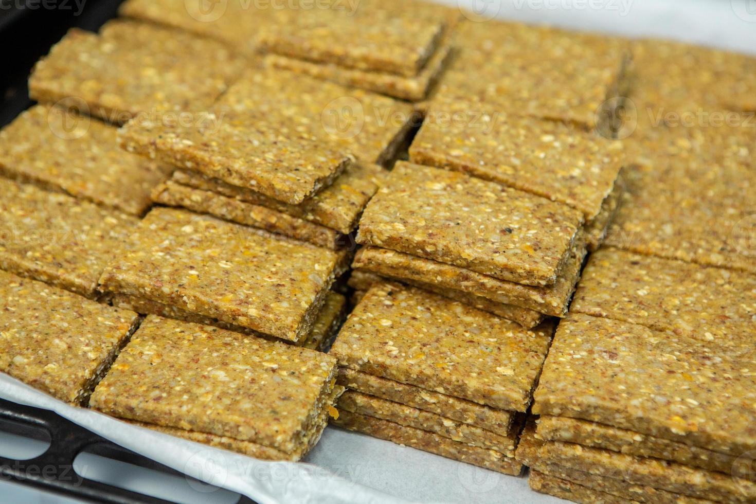 Assortment of cereal or protein bars that leave the assembly line at the factory. Healthy pre or post workout snacks with fruits, nuts and berries. photo