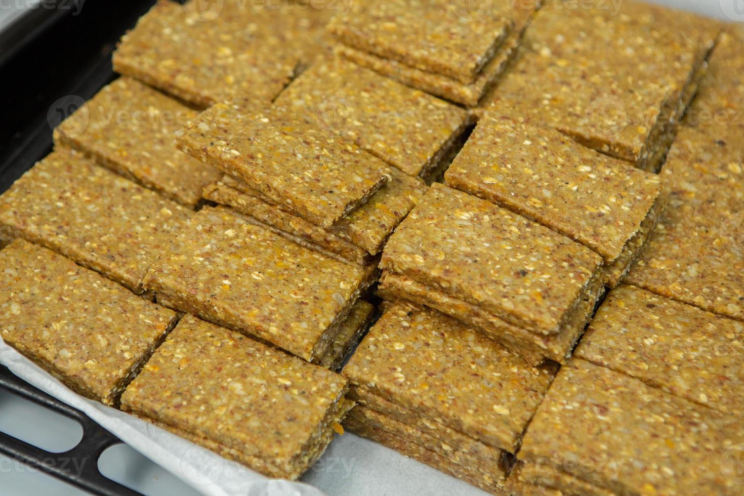 Assortment of cereal or protein bars that leave the assembly line at the factory. Healthy pre or post workout snacks with fruits, nuts and berries. photo