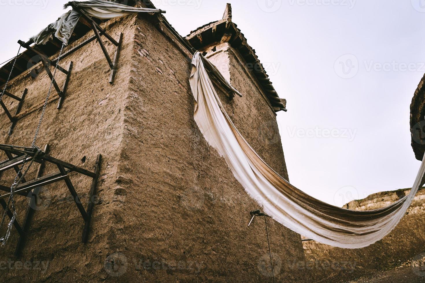 Abandoned adobe houses by the lakeside of Sailimu Lake photo