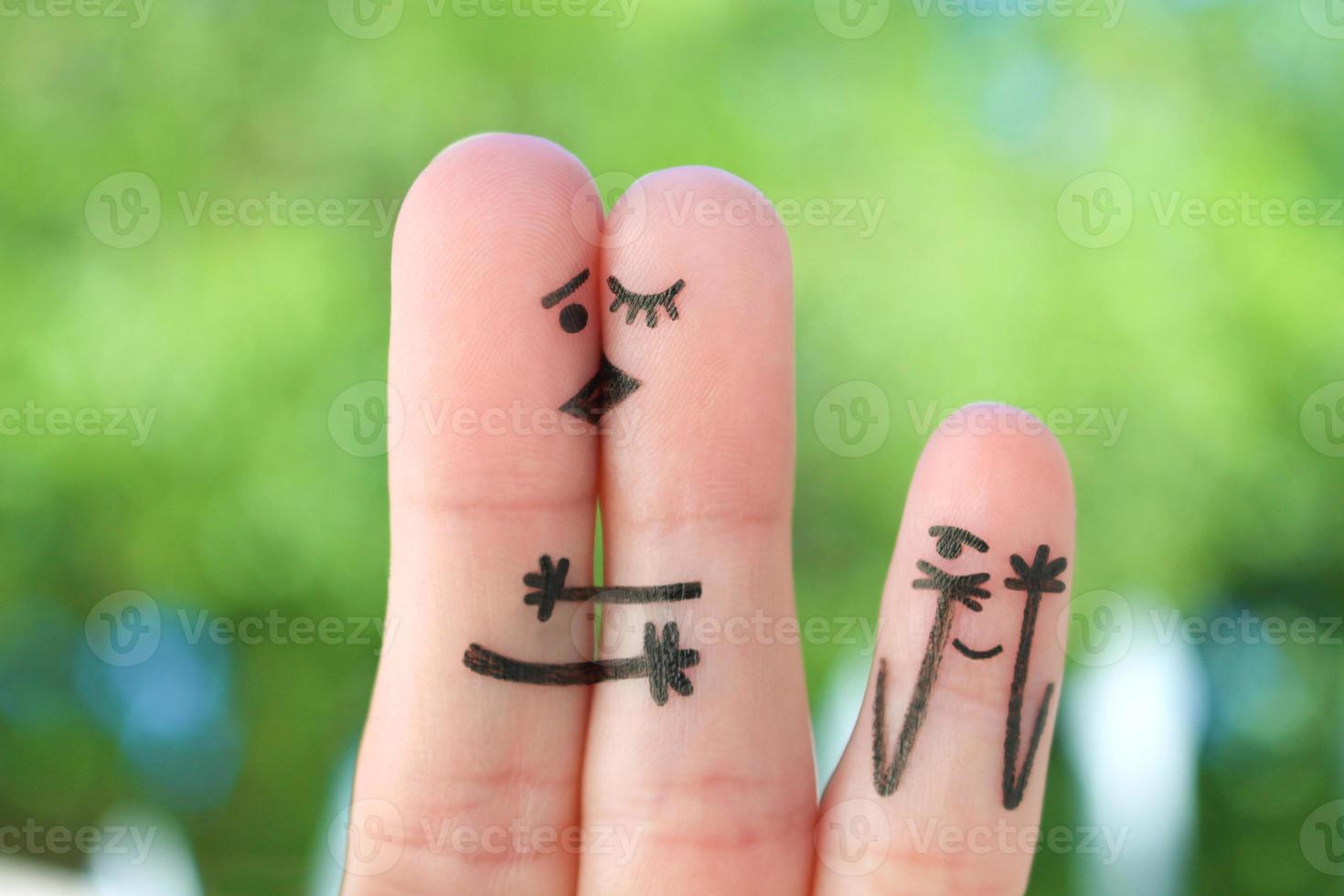 Fingers art of happy family. Concept of couple kisses,  child spies on them. photo