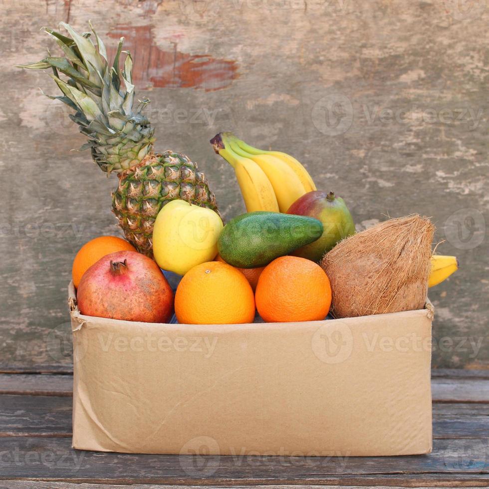 Donation box with food on old wooden background. photo