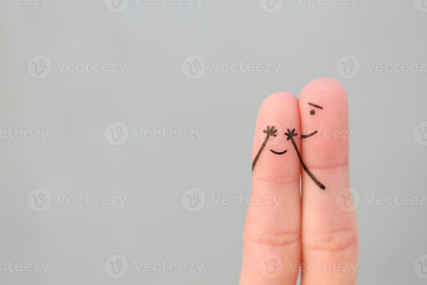 Fingers art of Happy couple. Boy closed her eyes to girl. Concept of girl guessed who closed his eyes. photo