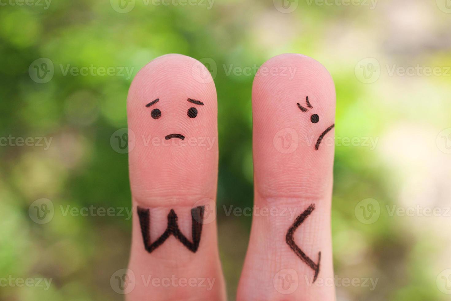 Fingers art of displeased couple. Woman was offended, man asks her forgiveness. photo