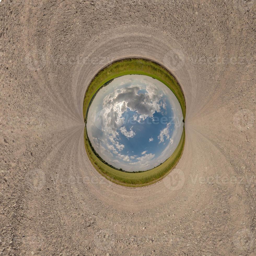 blue sphere little planet inside gravel road or field background. curvature of space photo