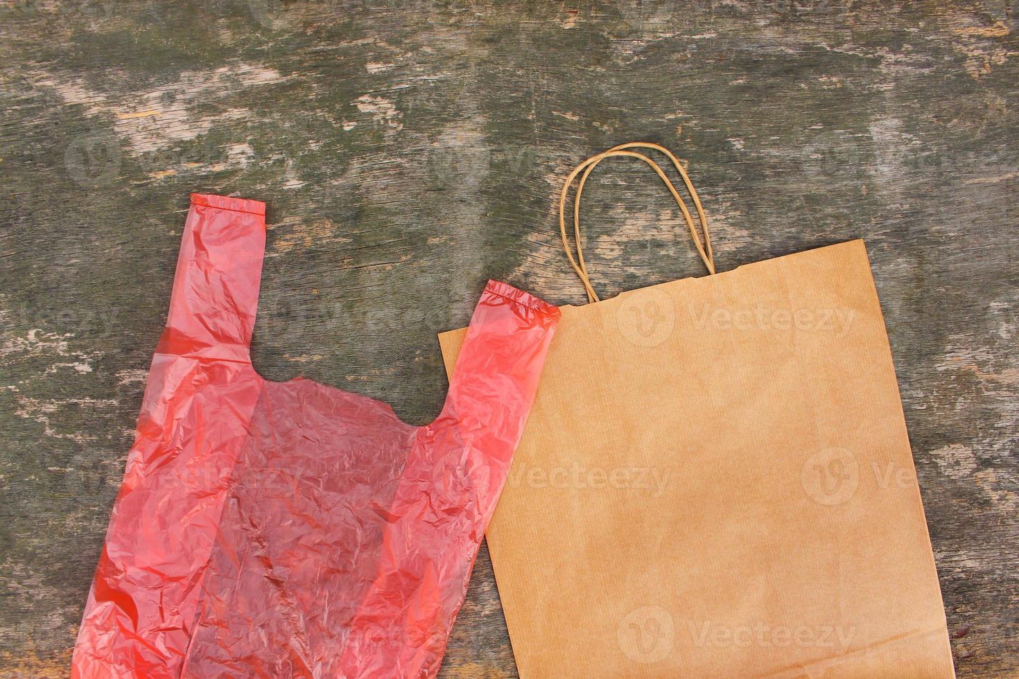 Two different bags of paper and polyethylene on an old wooden background. Top view. Flat lay. photo
