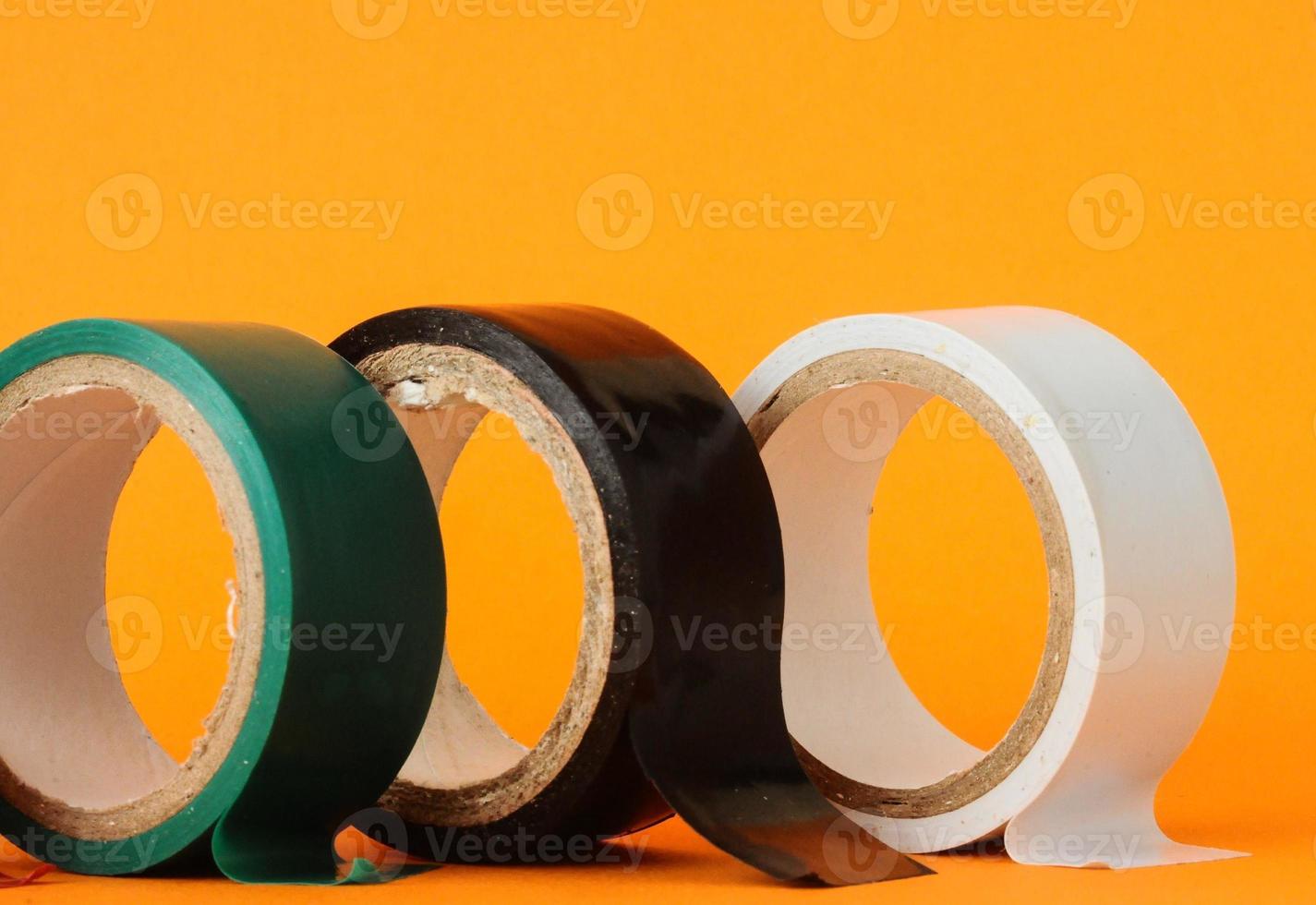 Adhesive tapes on yellow background photo