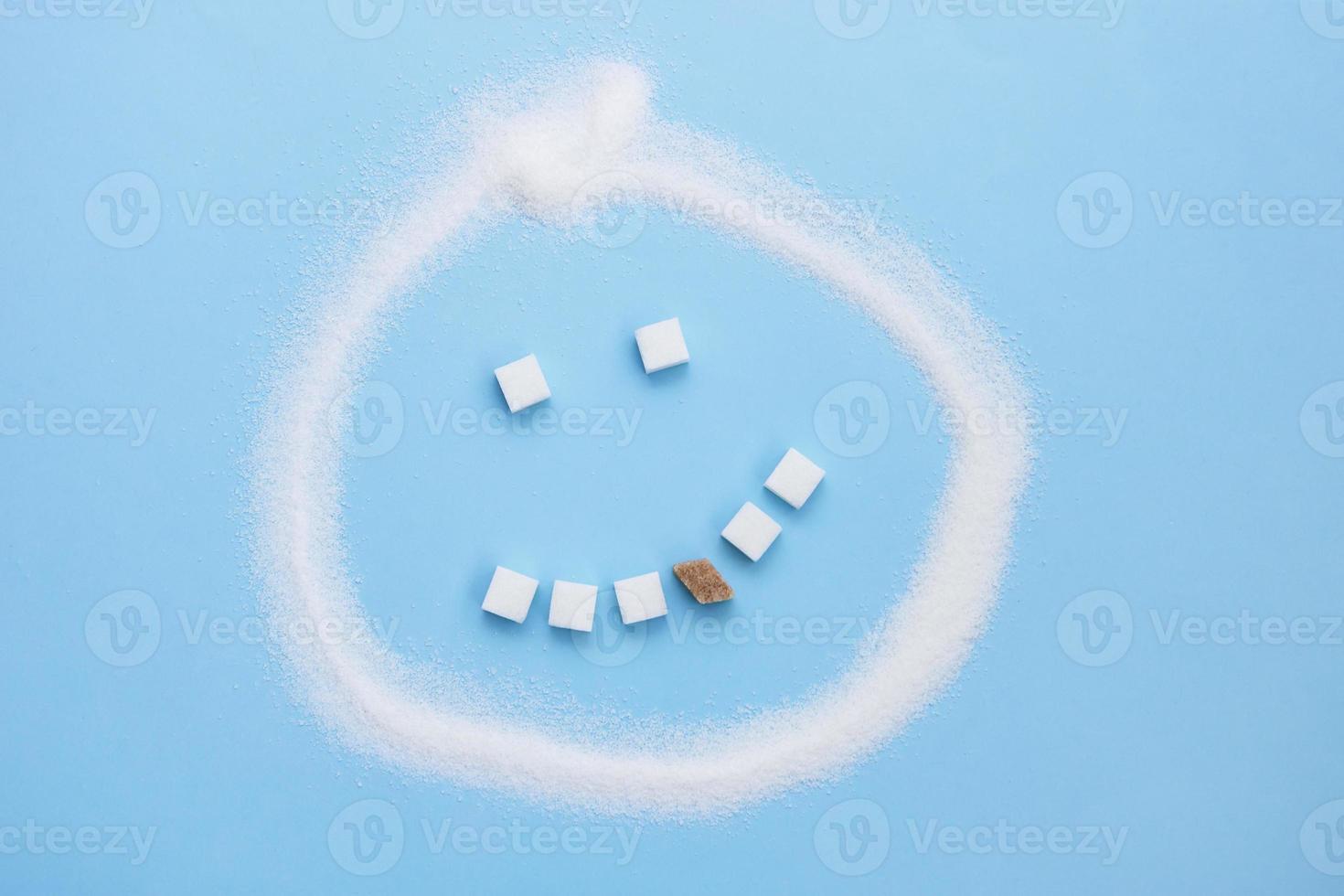 Sugar emoticon, sugar cube teeth with one carious brown sugar cube tooth, junk food photo