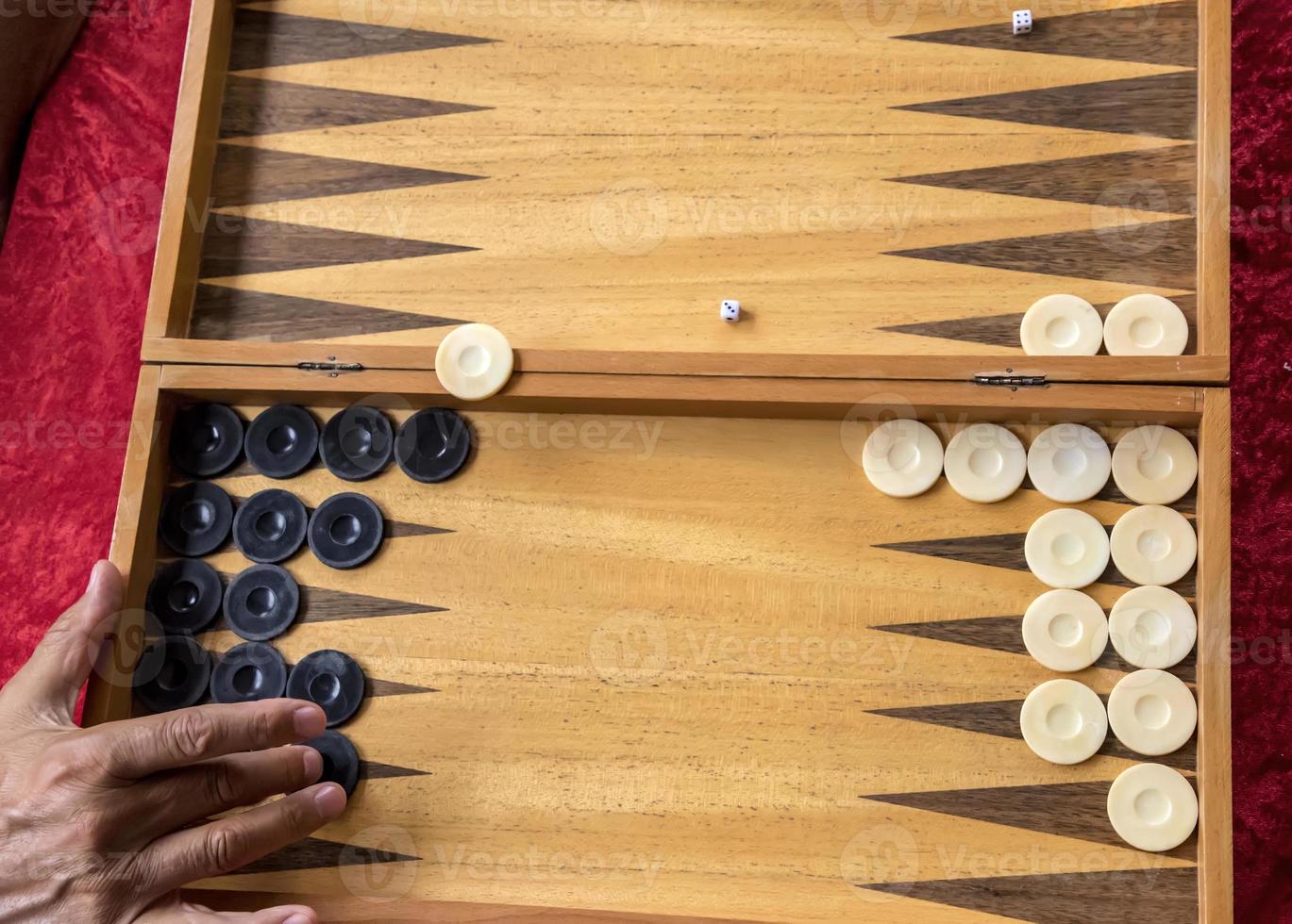 a man moves a pool in a backgammon game photo