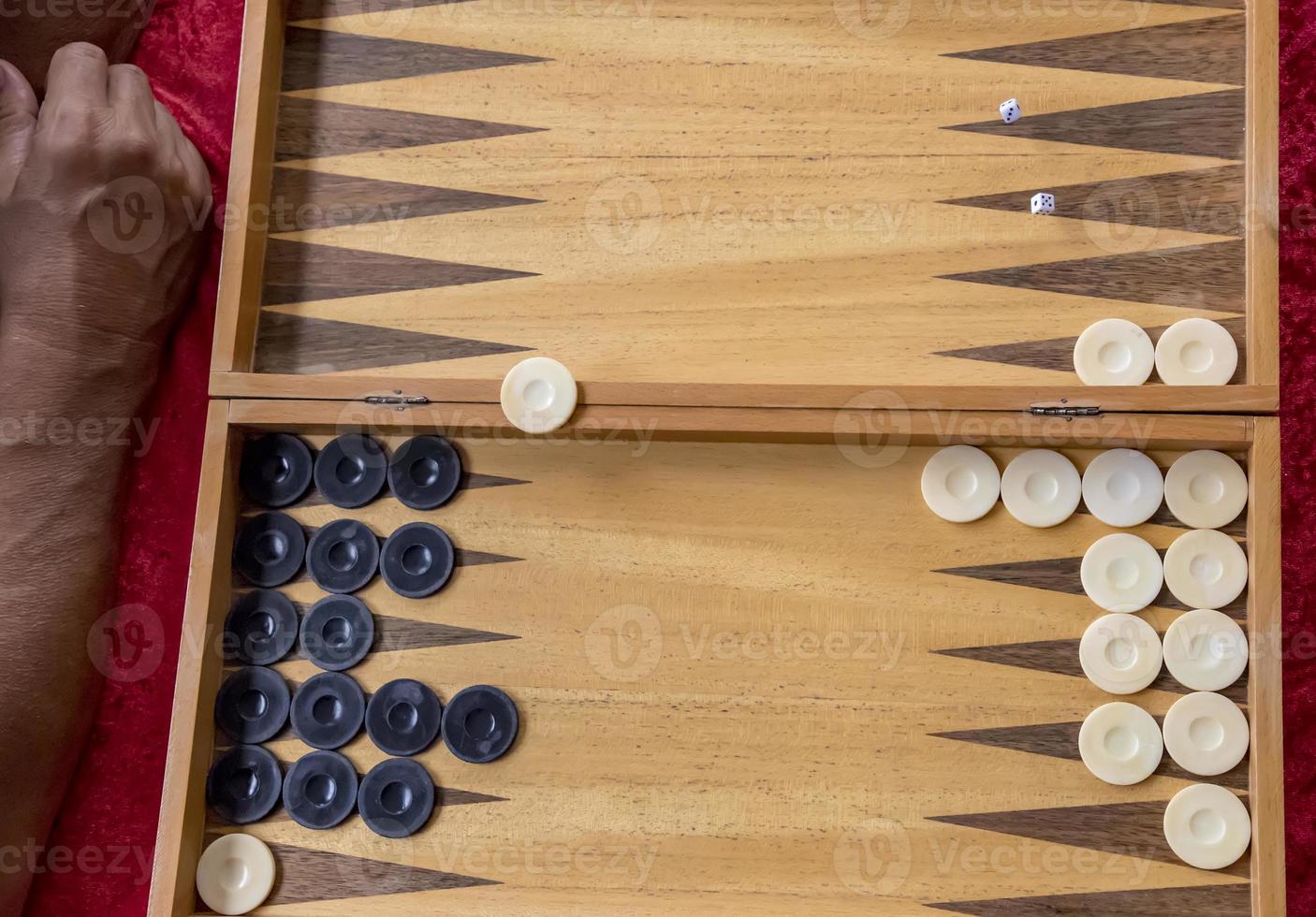 man throws dice while playing tabla. photo