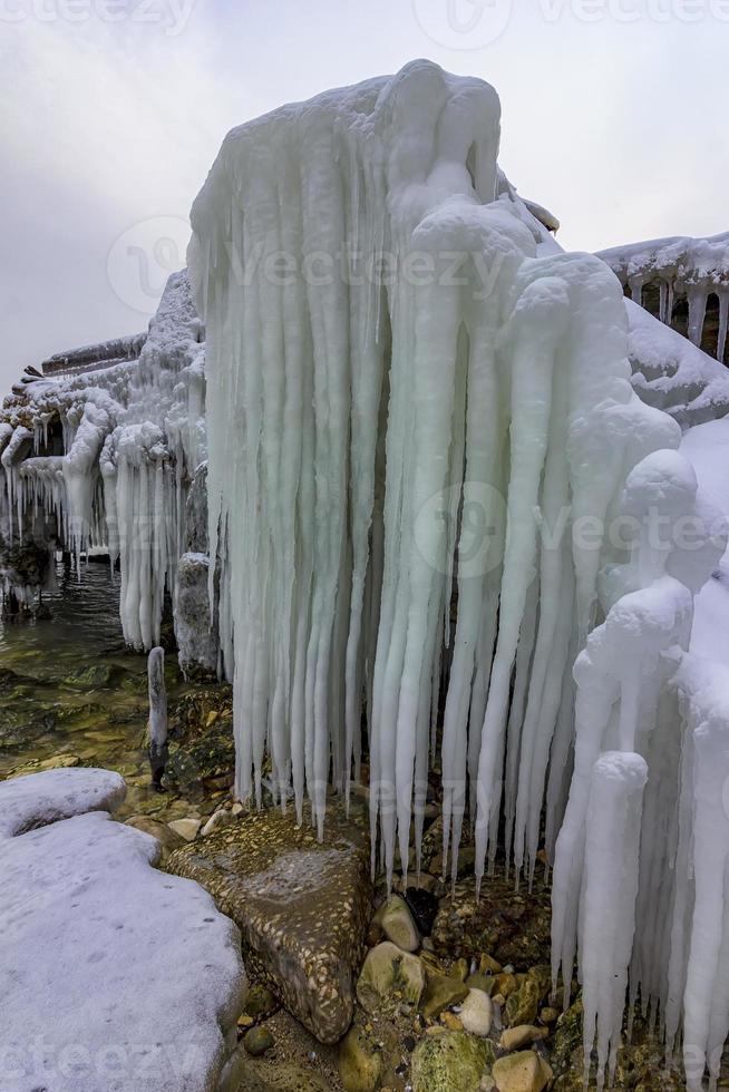 Beautiful big icicles over the old abandoned bridge photo