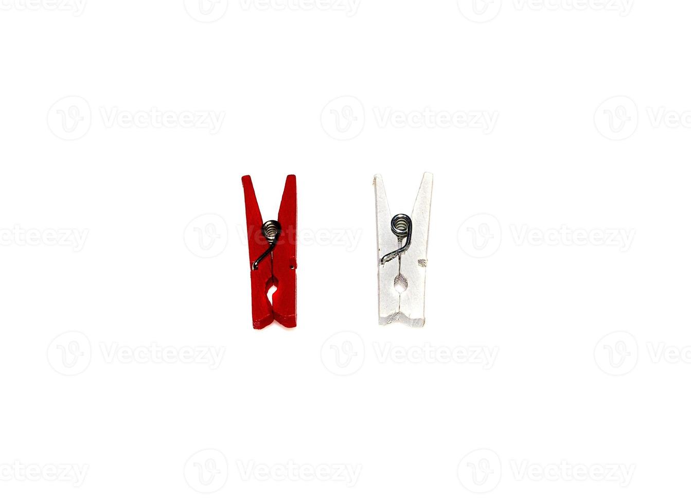 a red and white clothespin or clothes pegs isolated on white background photo