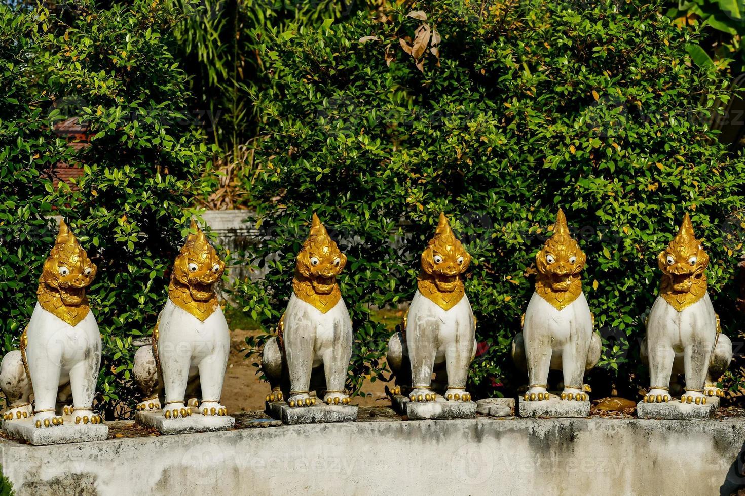 Buddhist sculptures at a temple in Bangkok, Thailand photo