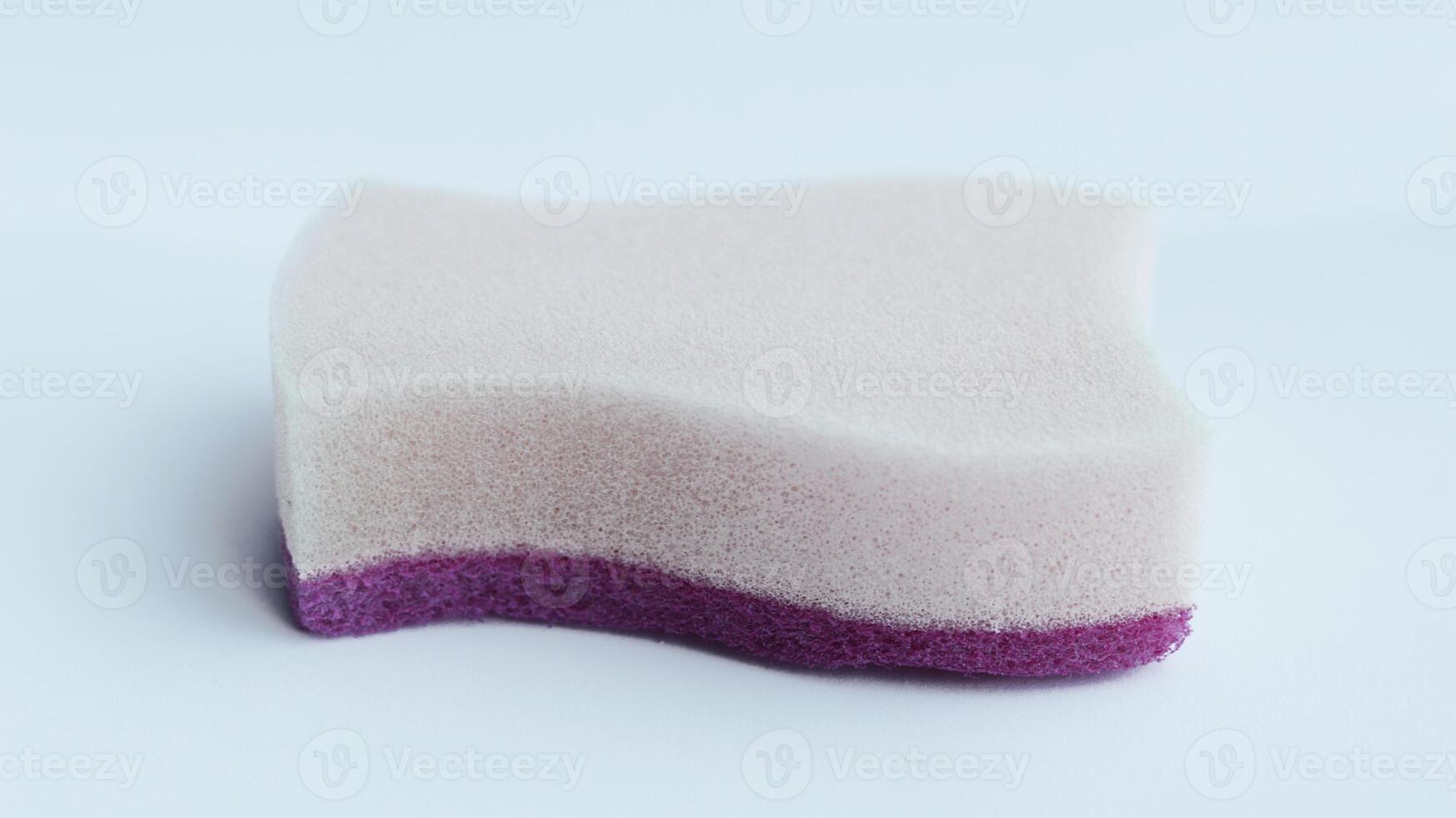 Magenta foam sponge isolated on white for cleaning and washing dishes. photo