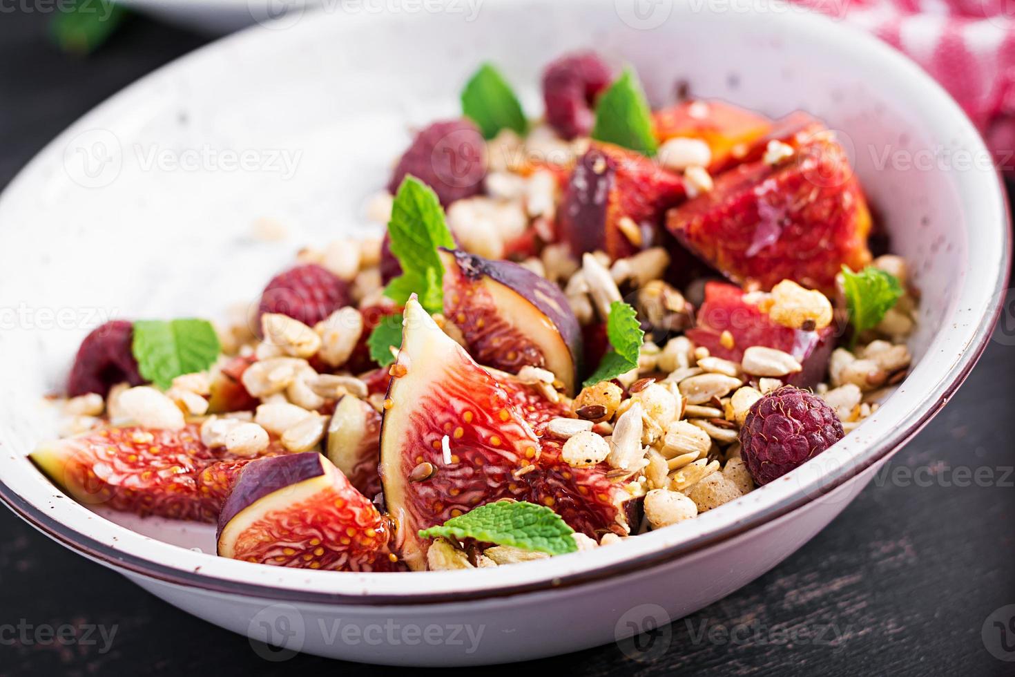 Chia seed pudding made with raspberries,  figs and mint on dark background.  The concept of good nutrition. photo