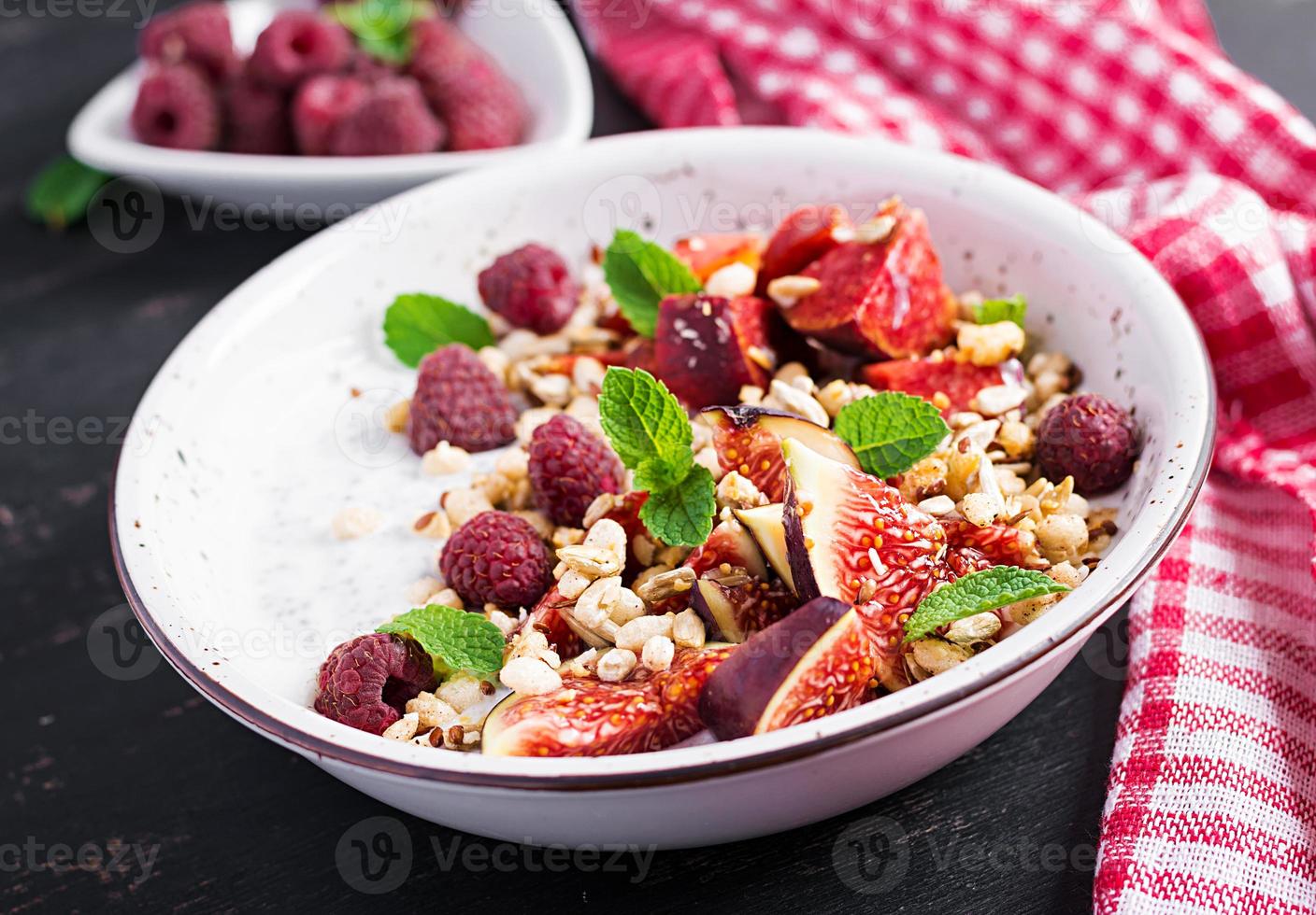 Chia seed pudding made with raspberries,  figs and mint on dark background.  The concept of good nutrition. photo