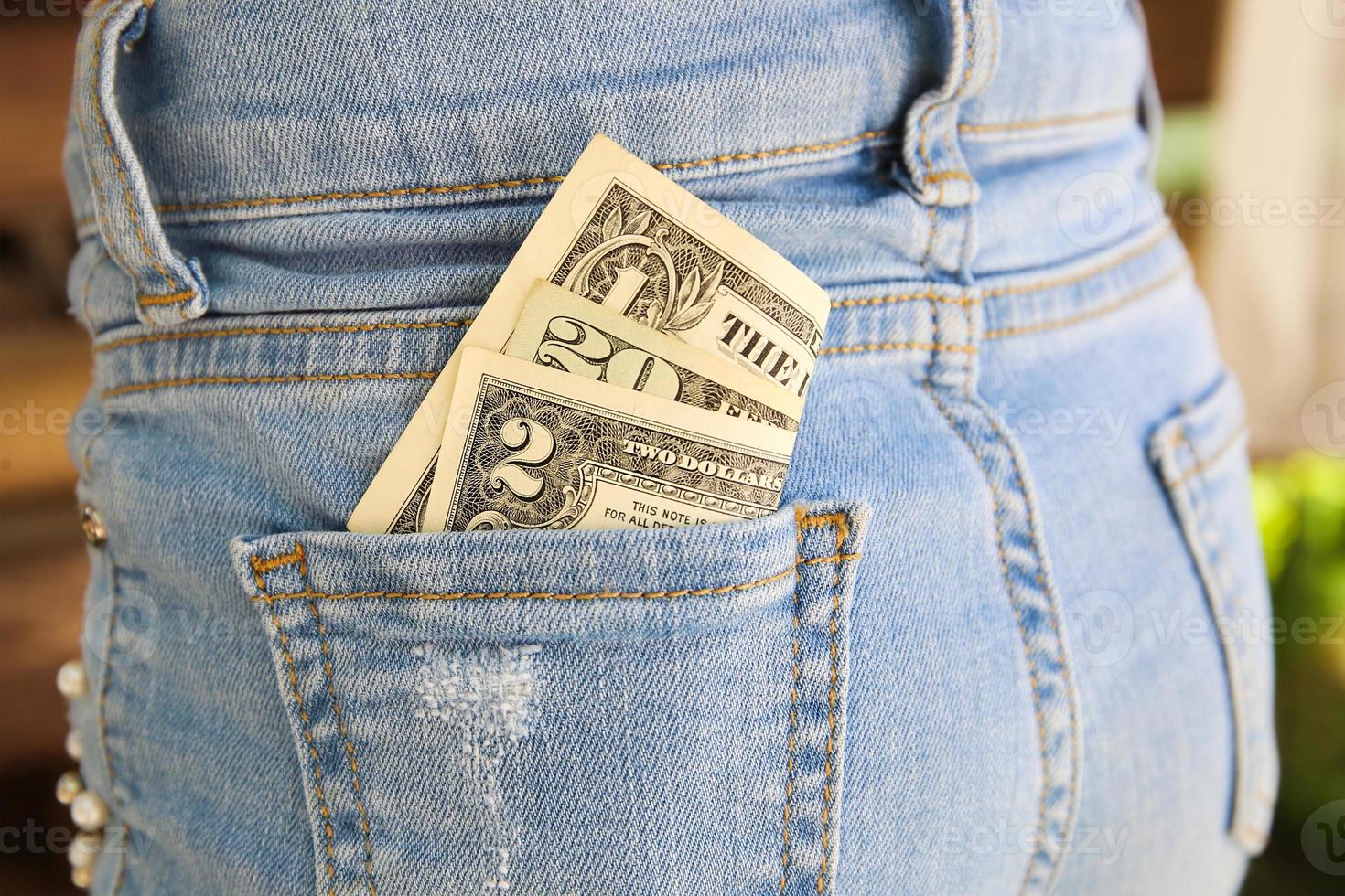 Dollars in pocket of jeans. photo