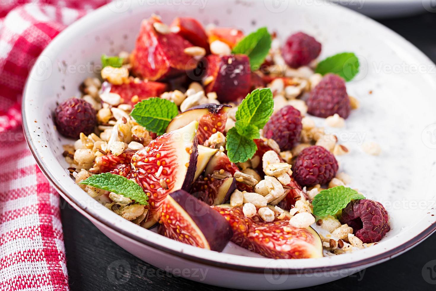 Chia seed pudding made with raspberries,  figs and mint on dark background.  The concept of good nutrition. photo