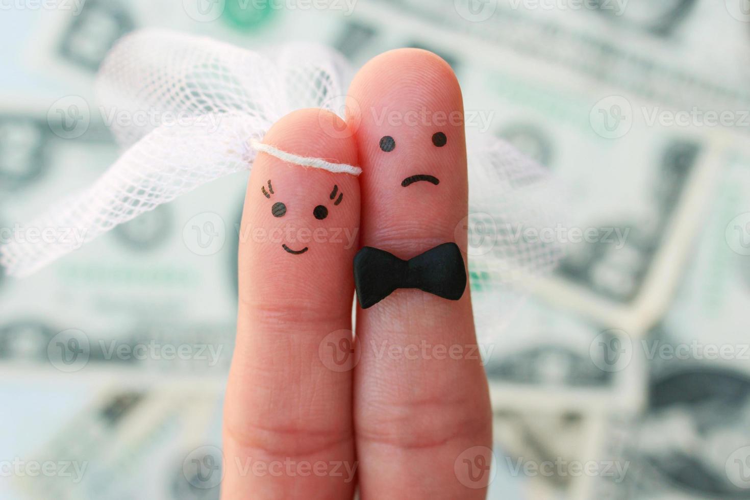 Fingers art of couple on background of money. Concept of woman is happy, and man does not want to get married. photo