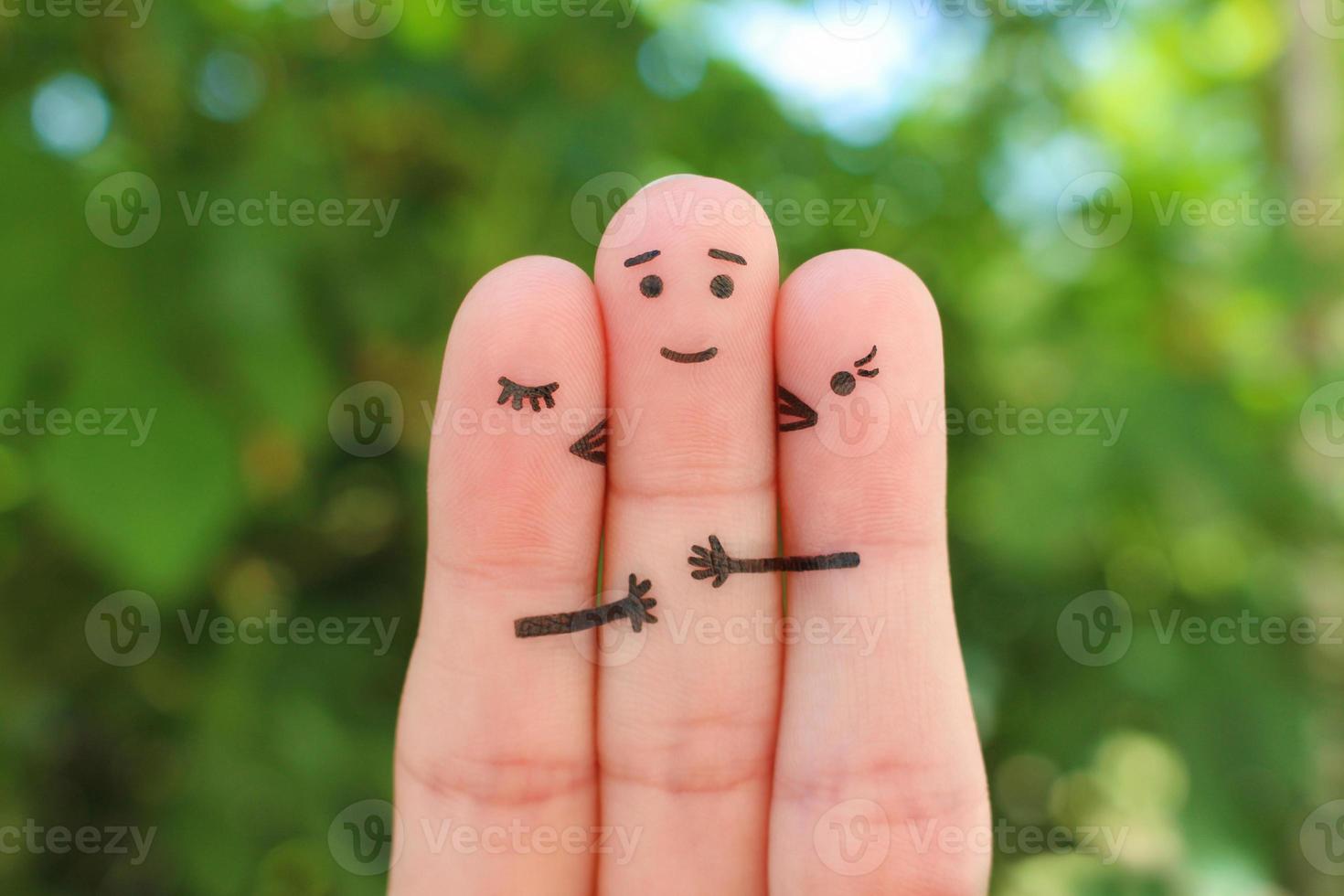 Fingers art. Concept of girls kisses boy on cheek. photo