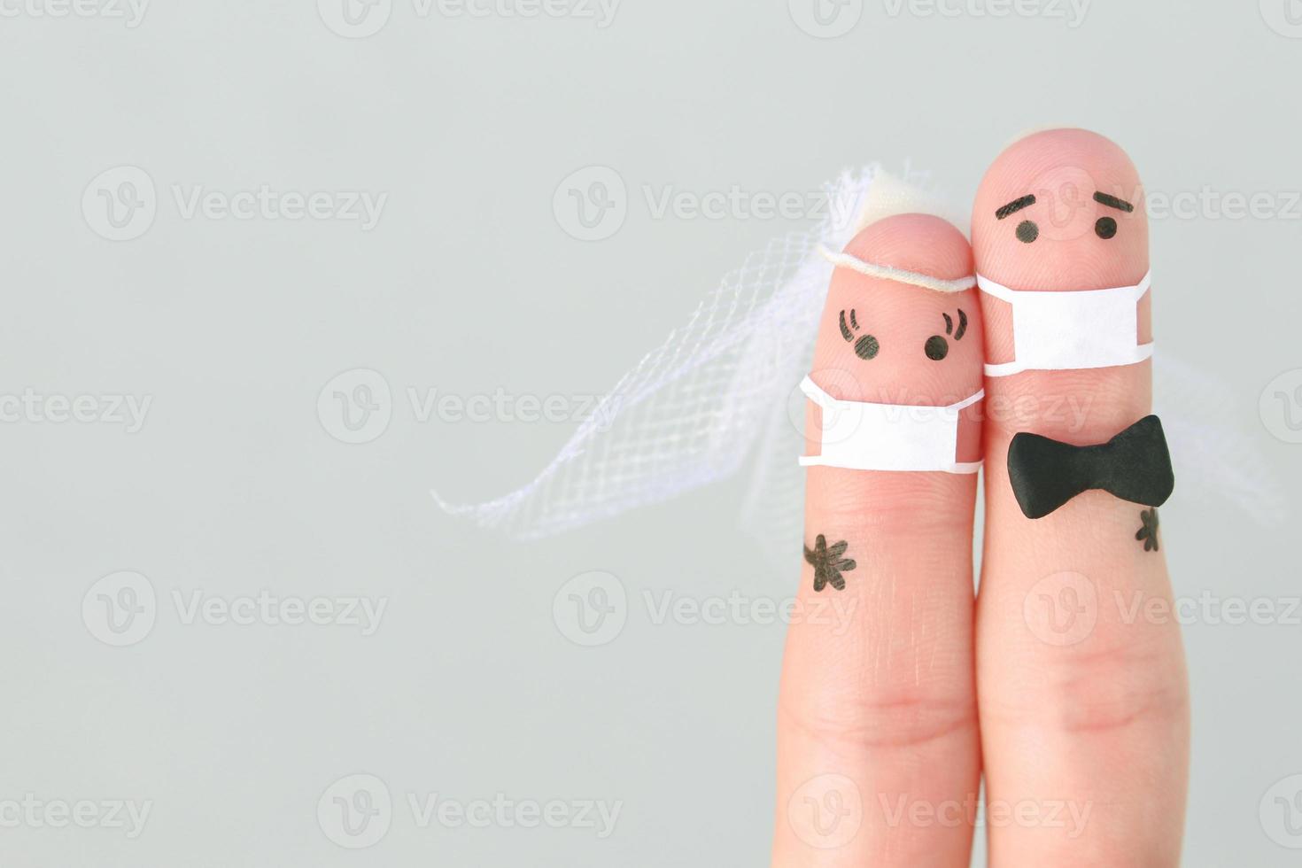 Fingers art of happy couple in medical mask from COVID-2019. Concept of wedding ceremony. photo