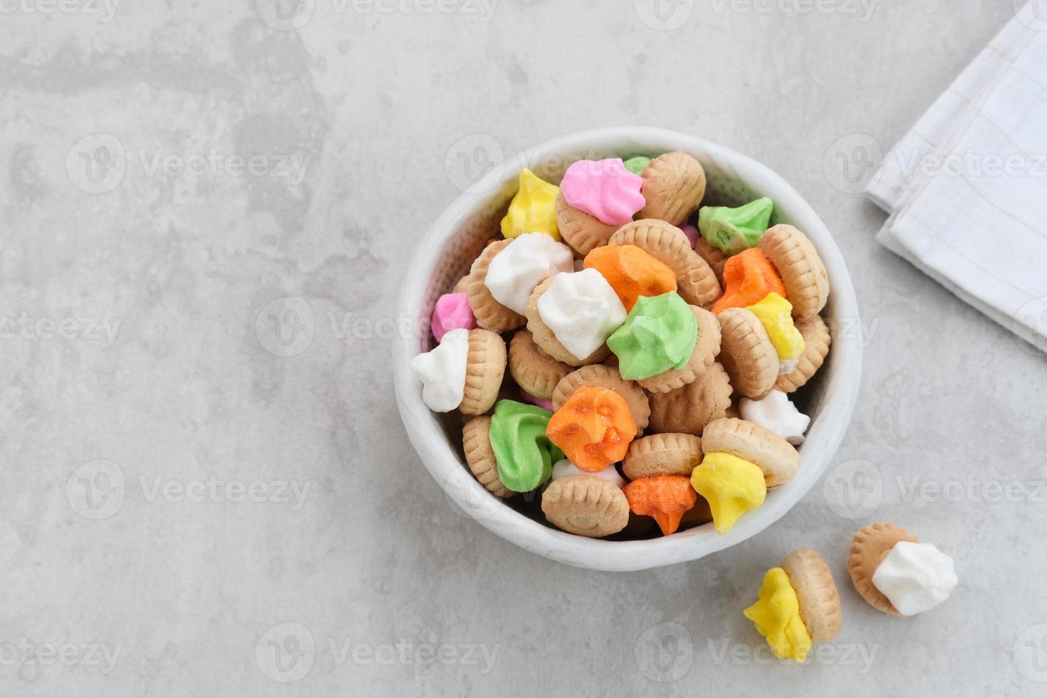 Gemrose or button cookies topped with colorful icing sugar. Indonesian traditional biscuits photo