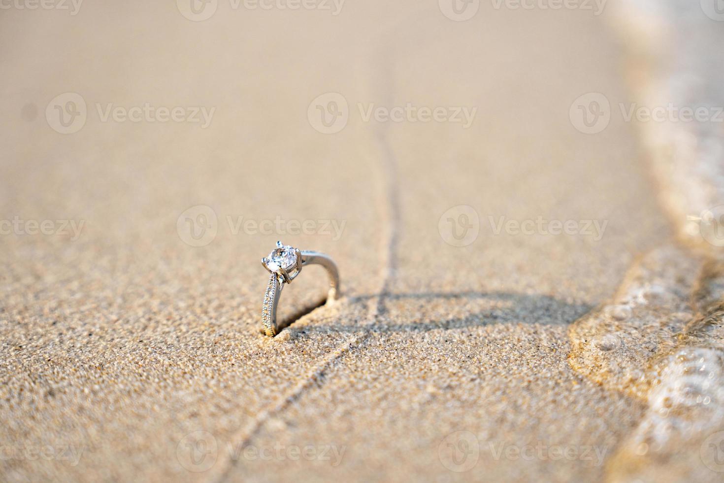 Diamond rings on the sand. And they are wedding rings. backgrounds textures photo