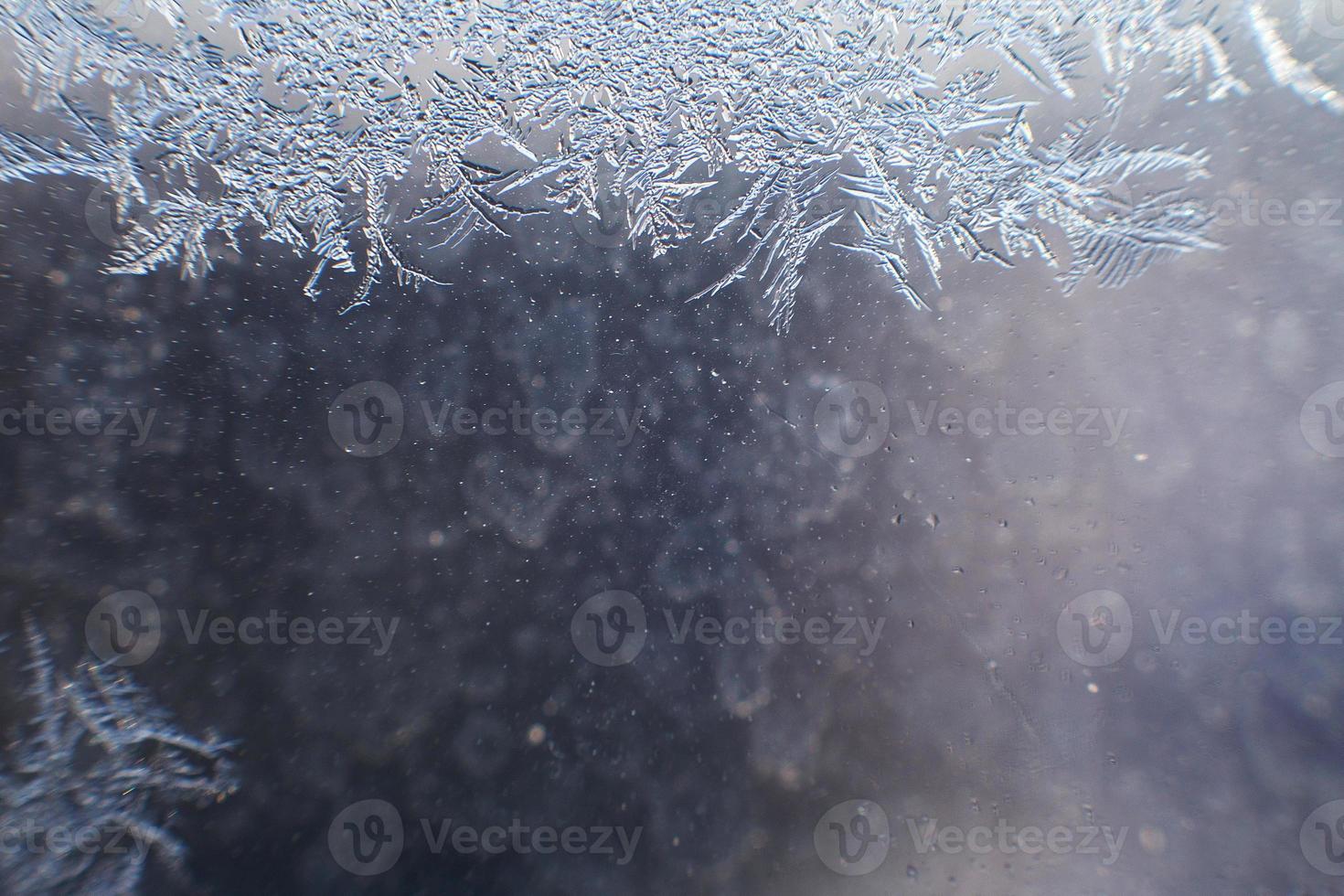 snow pattern on the glass from frost photo