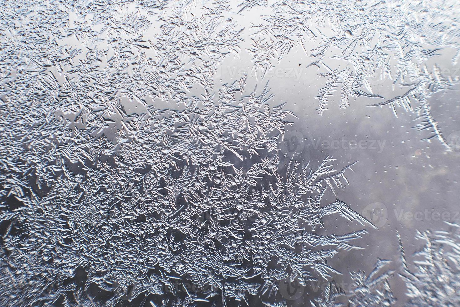 snow pattern on the glass from frost photo