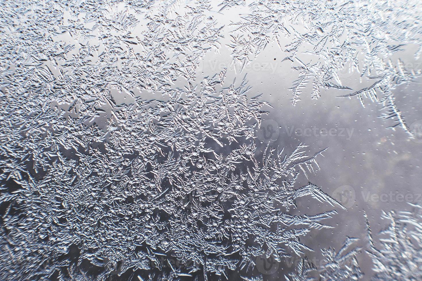 snow pattern on the glass from frost photo