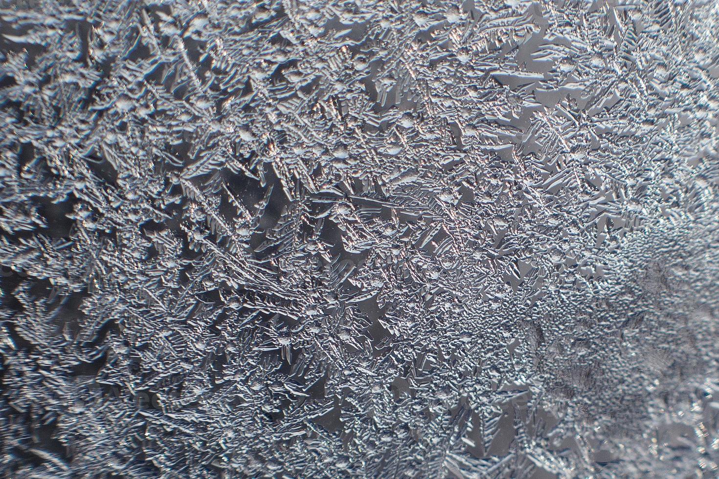 snow pattern on the glass from frost photo
