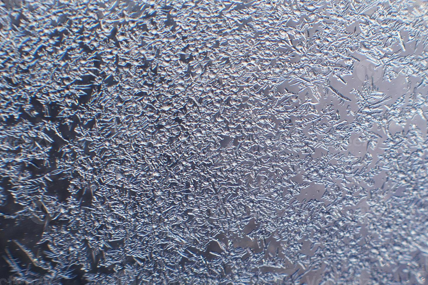 snow pattern on the glass from frost photo