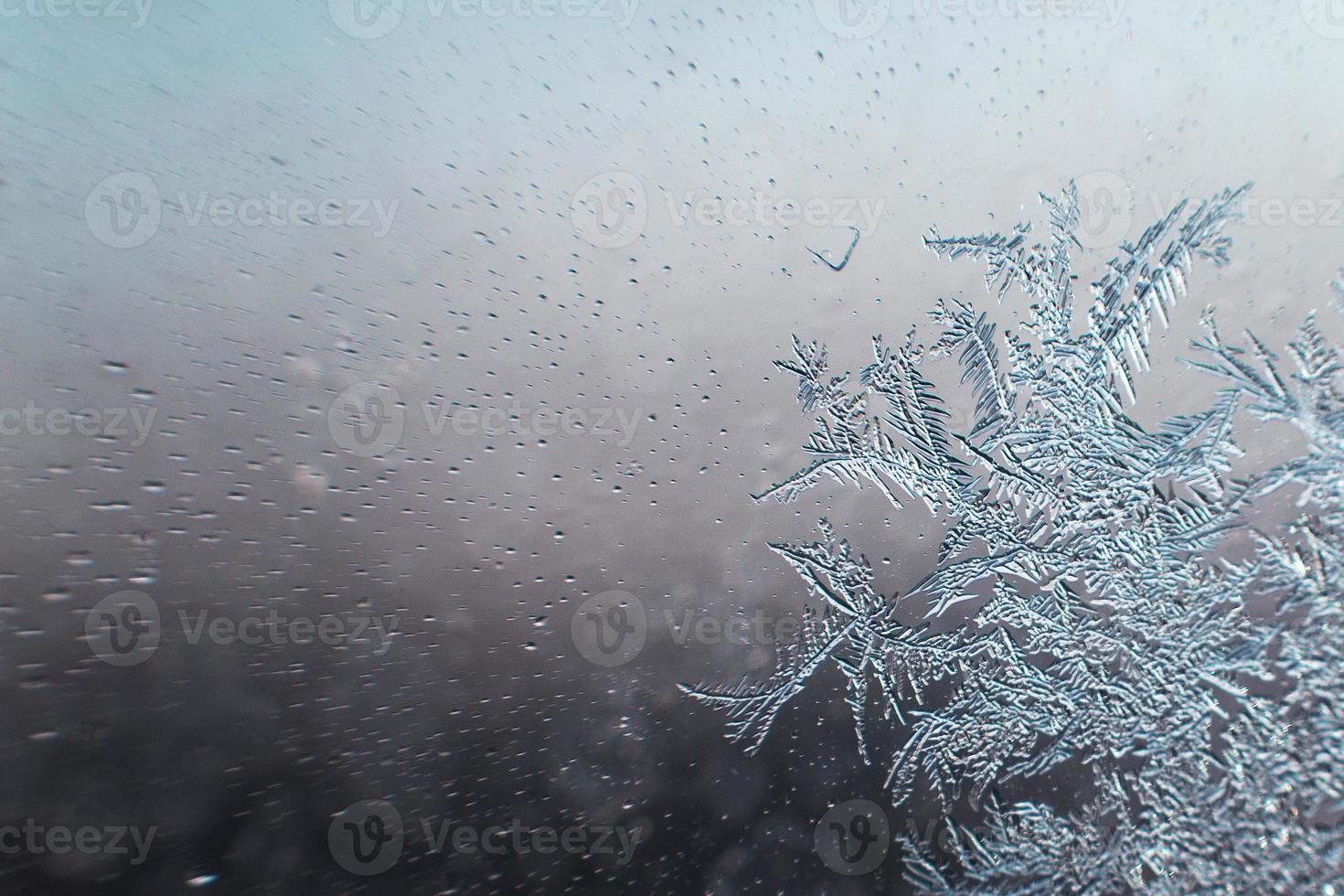 snow pattern on the glass from frost photo