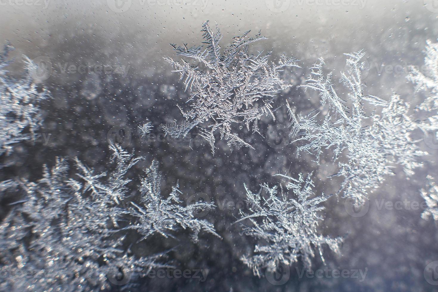snow pattern on the glass from frost photo