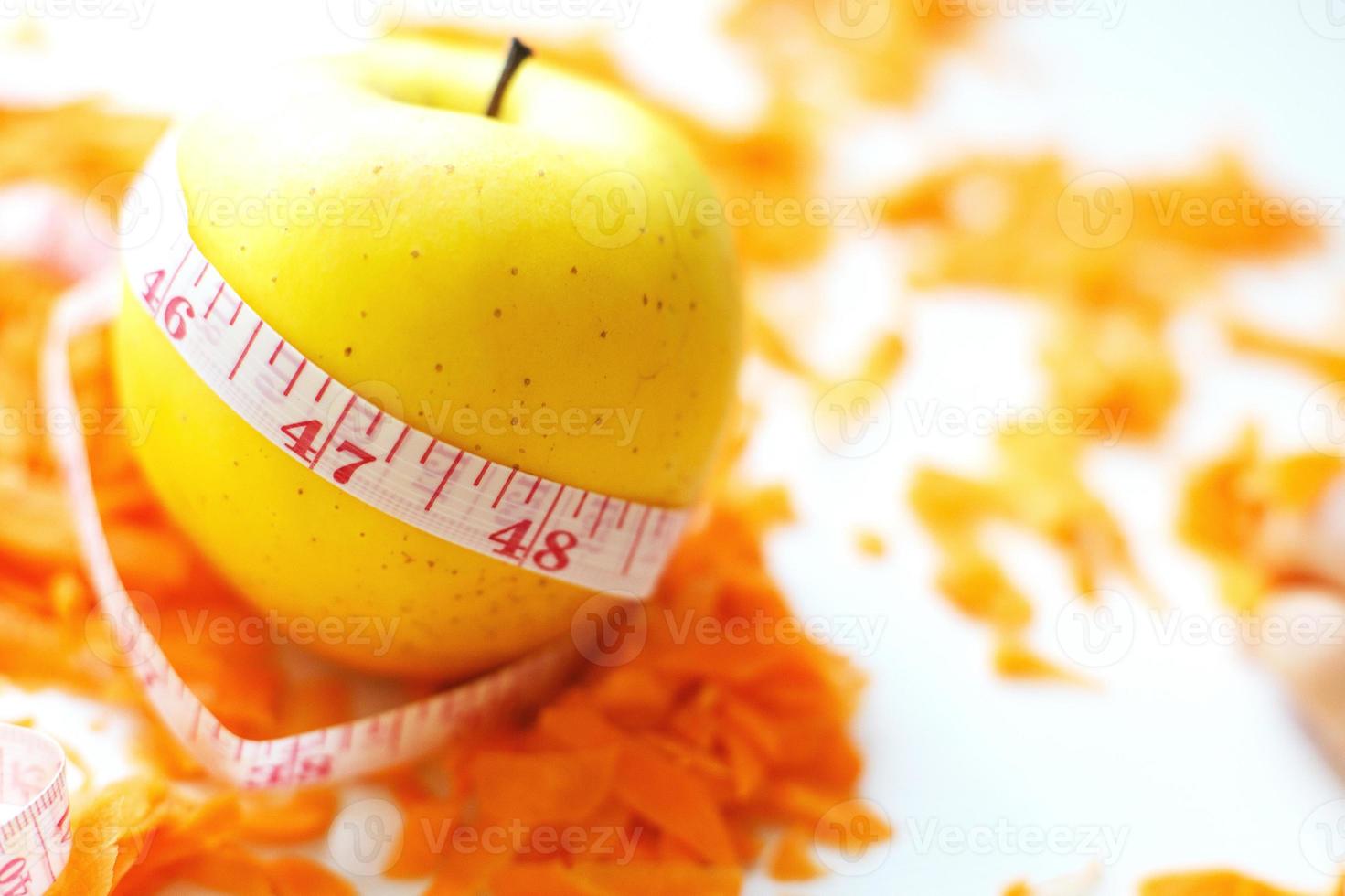 chopped carrots and apple on a white background. fruits and vegetables healthy food for diet photo