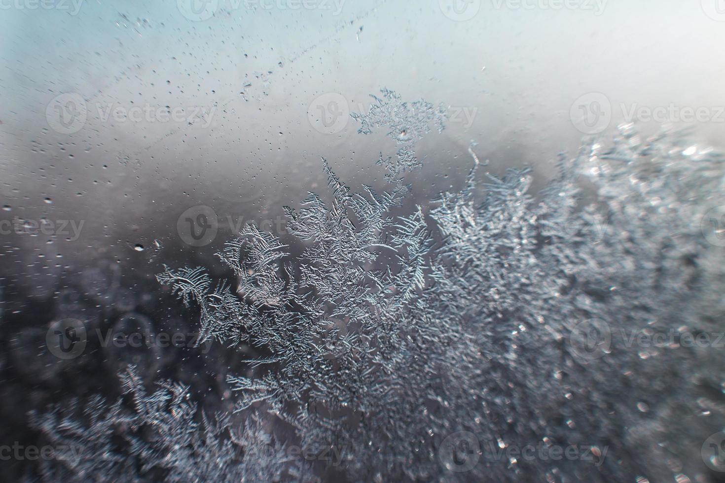 snow pattern on the glass from frost photo