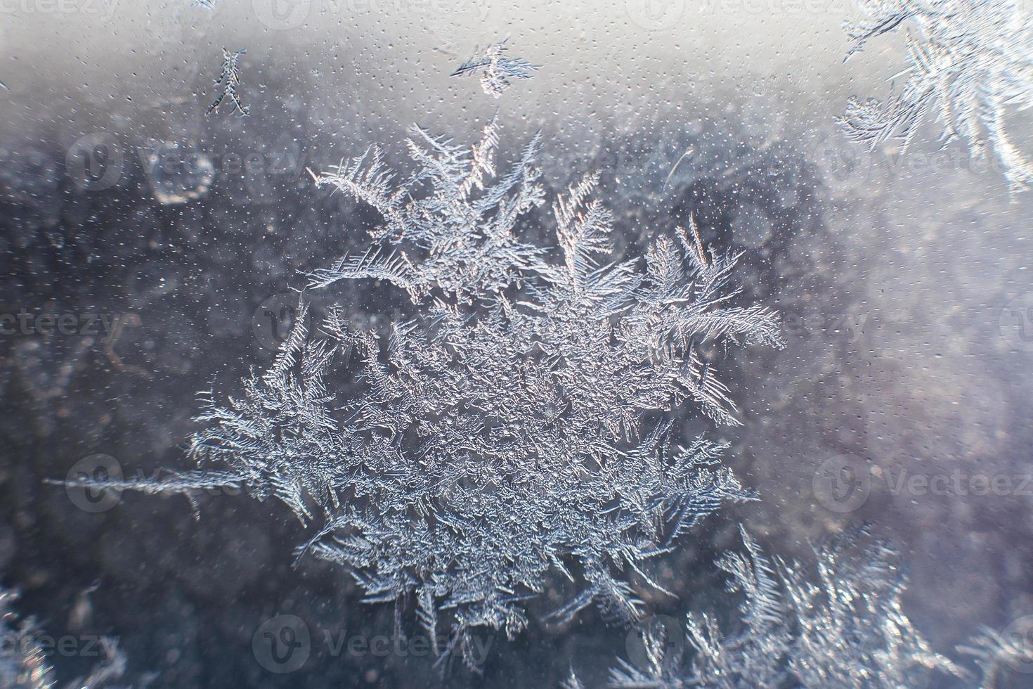 snow pattern on the glass from frost photo