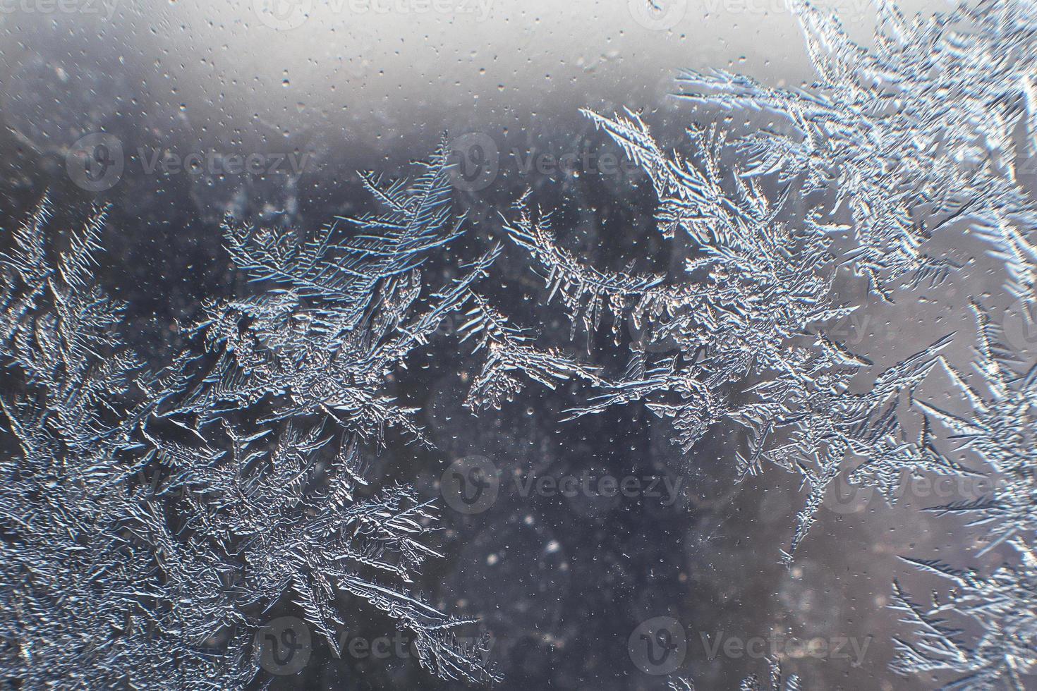 snow pattern on the glass from frost photo