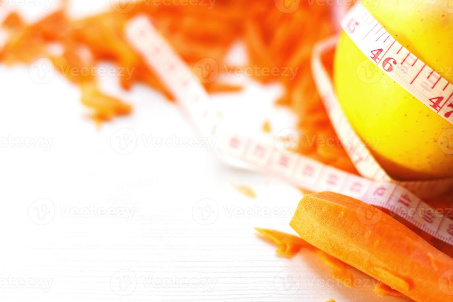 chopped carrots and apple on a white background. fruits and vegetables healthy food for diet photo