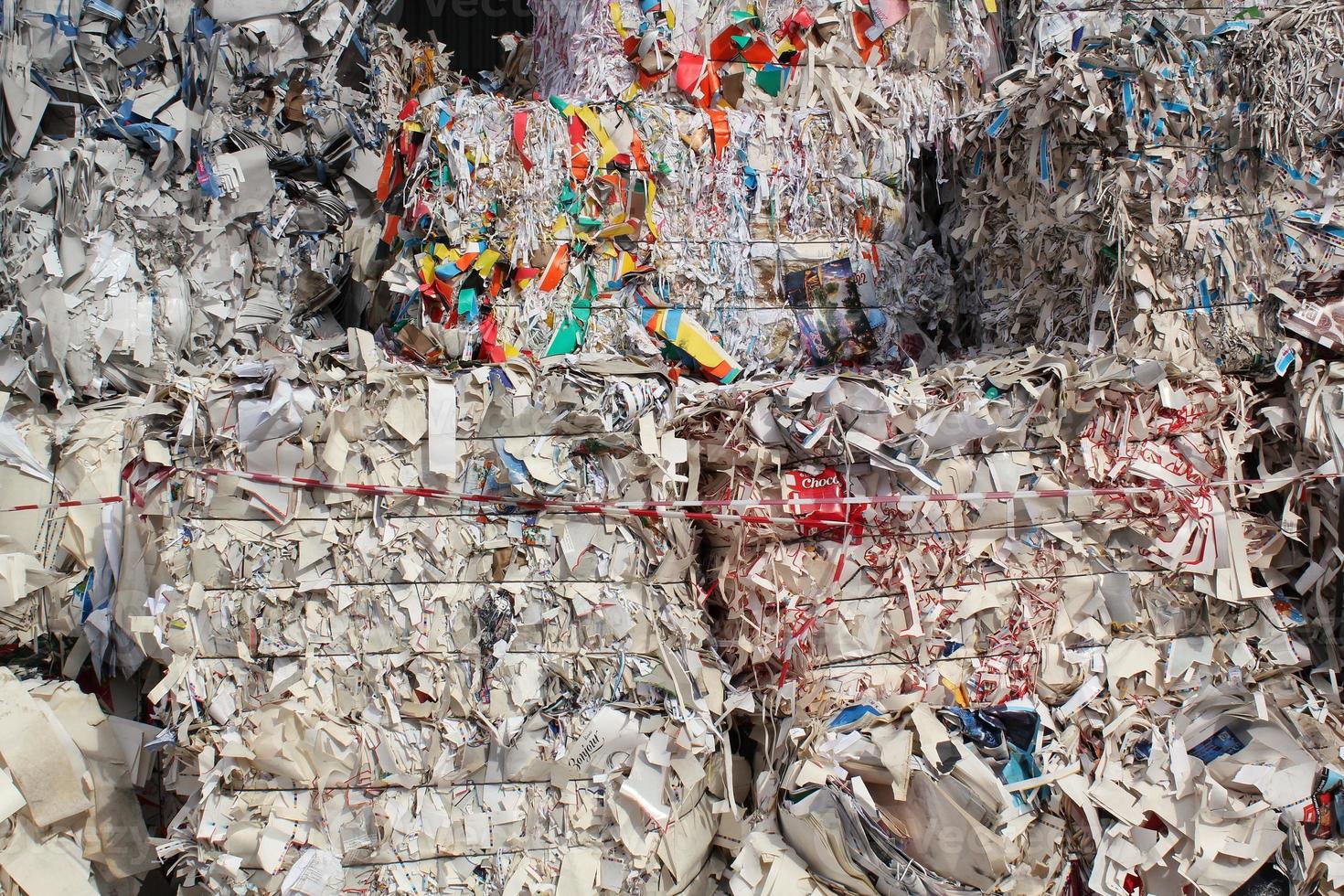 Wastepaper compact texture pile for recycling on sorting plant. Technology of reuse materials. Stack of shredded paper. Save the planet ecology concept. Industry of reduced pollution factory. Close-up photo