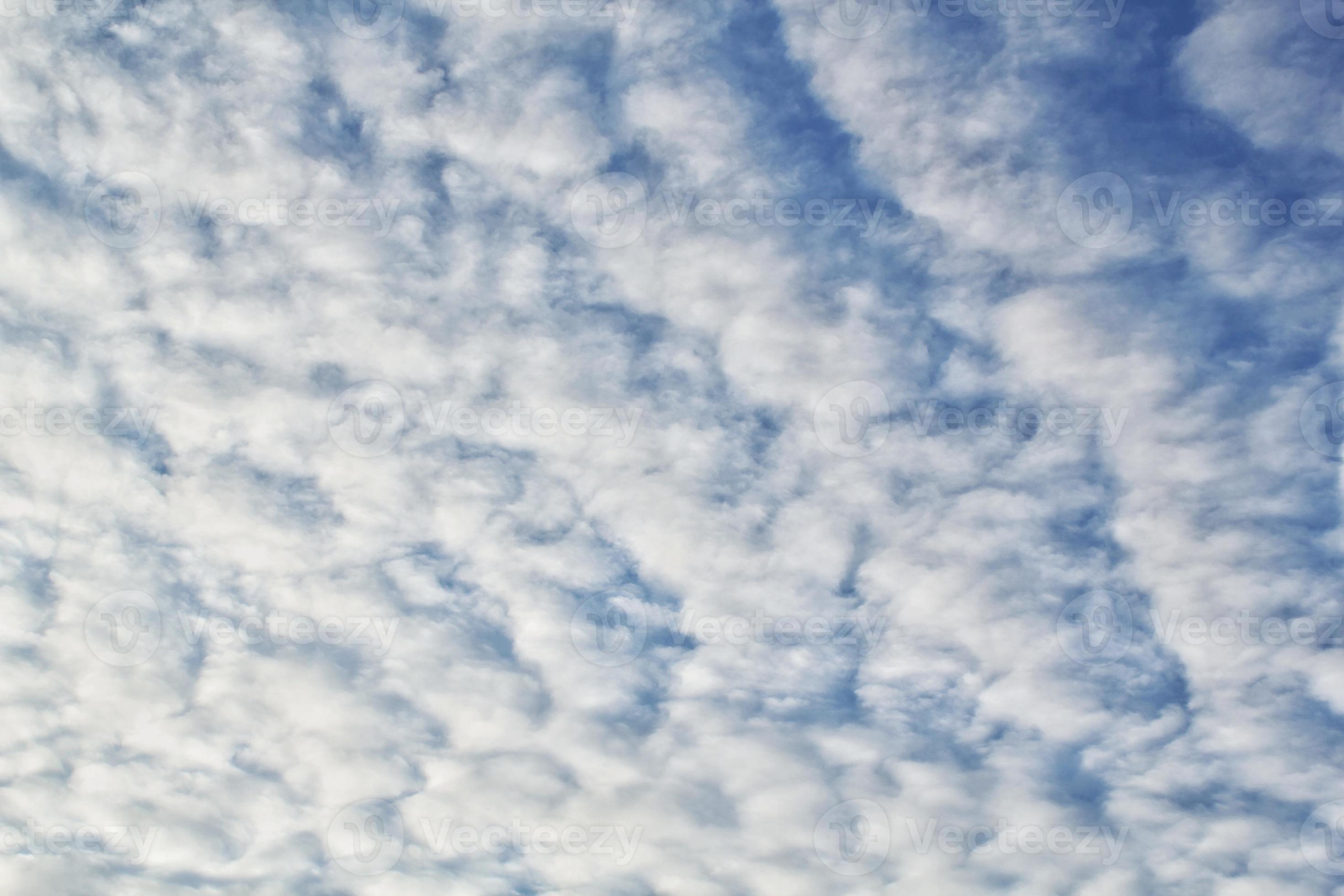 Fluffy white cloud, floating in clear blue sky