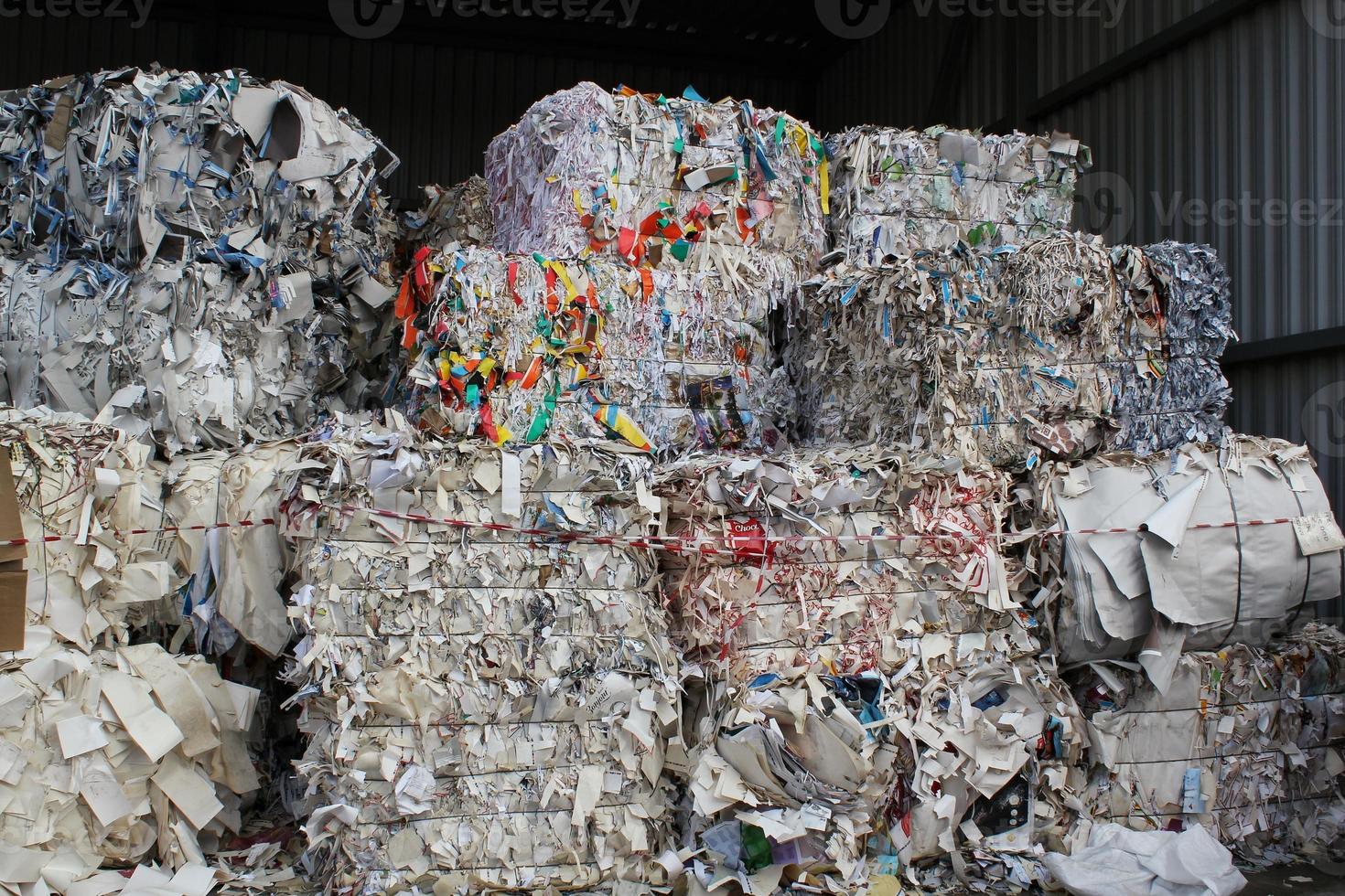 Wastepaper compact texture pile for recycling on sorting plant. Technology of reuse materials. Stack of shredded paper. Save the planet ecology concept. Industry of reduced pollution factory. Close-up photo