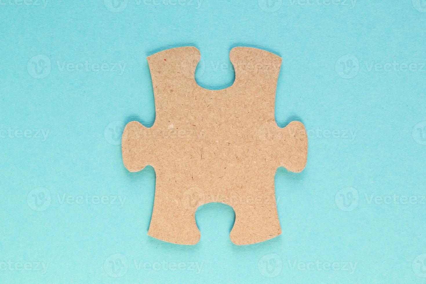 Carton mosaic game detail of jigsaw puzzle element on blue background. Completing task or solving problem concept. World mental health day, autism awareness day. Global communication. Hobby, play photo