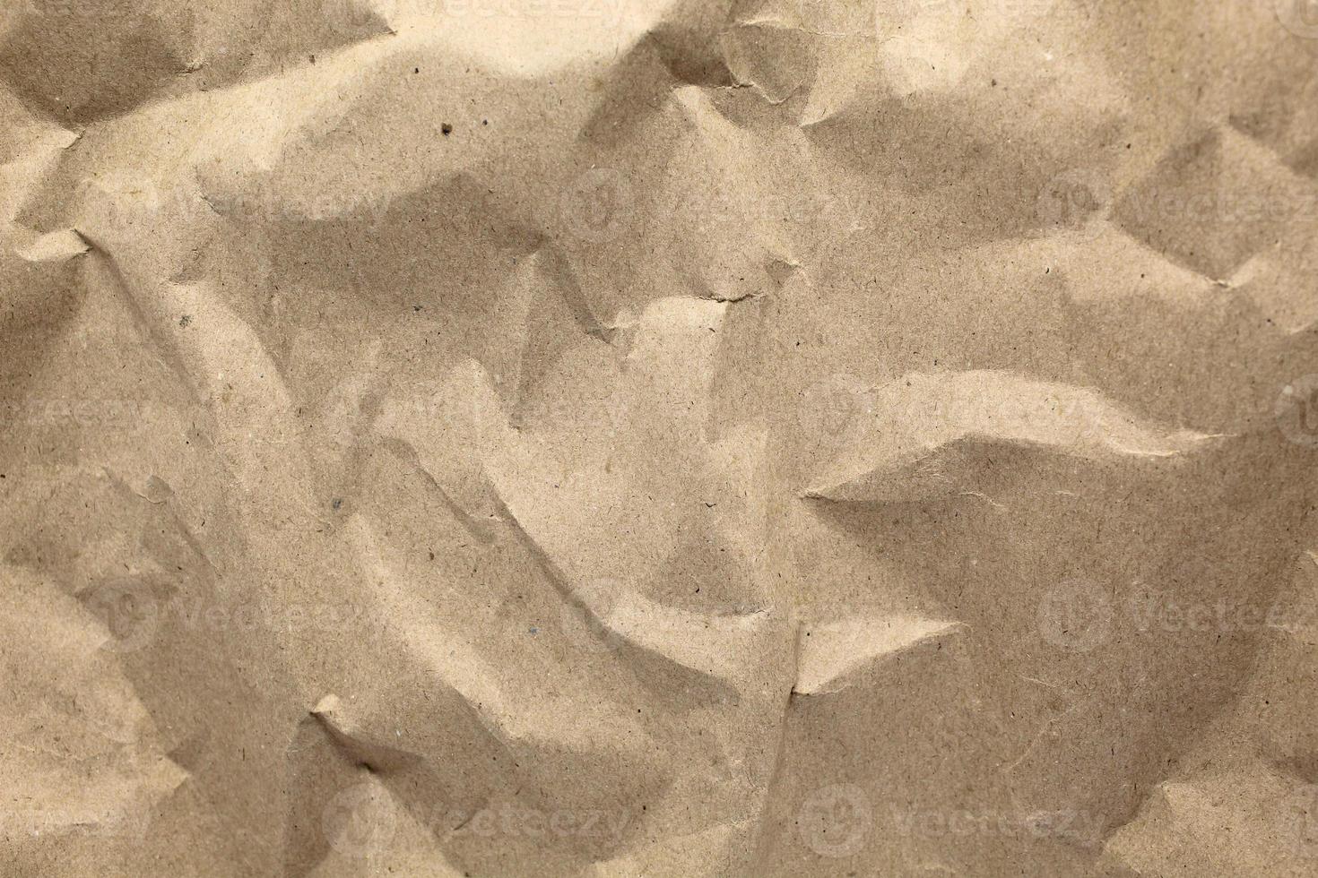 Craft crumpled paper, cardboard background. Brown kraft sheet texture, torn antique page, wallpaper or parchment abstract design, Horizontal rough carton, old material photo