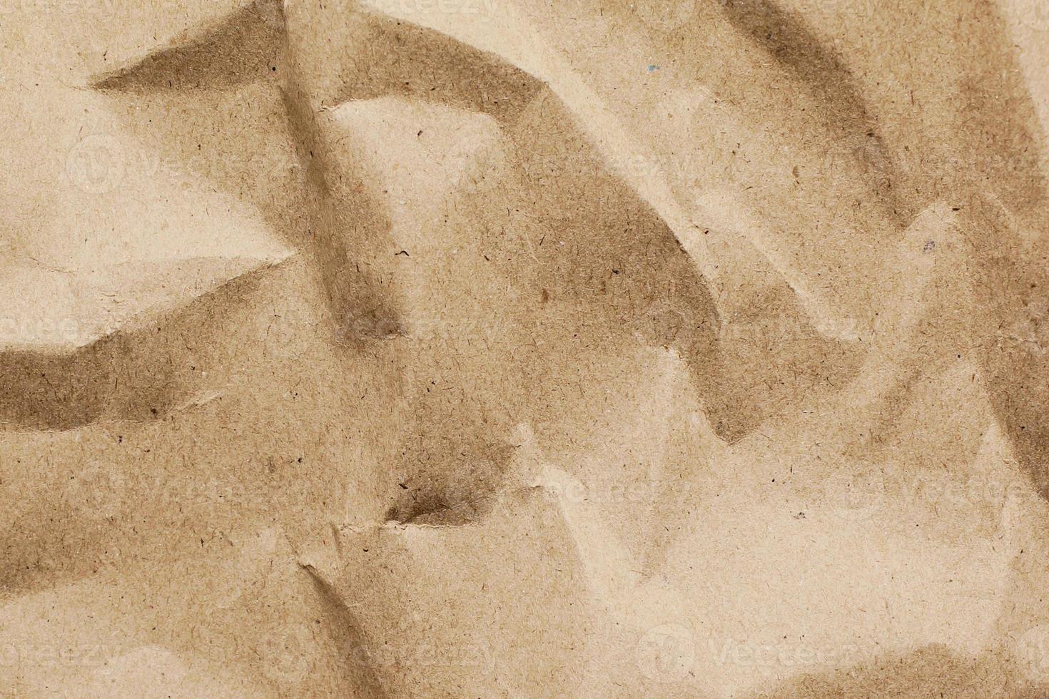 Craft crumpled paper, cardboard background. Brown kraft sheet texture, torn antique page, wallpaper or parchment abstract design, Horizontal rough carton, old material photo